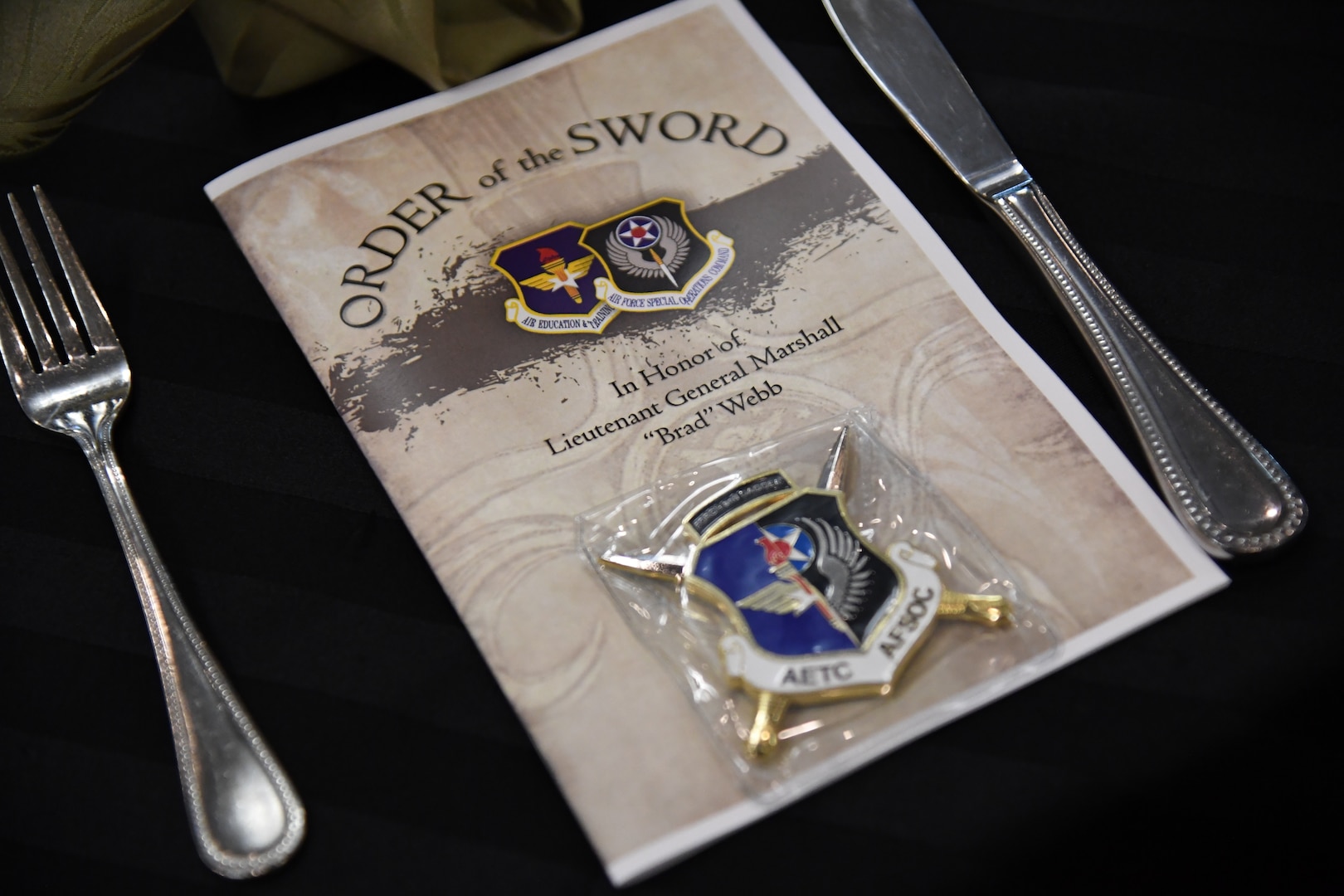 An event program is on display during the Order of the Sword Ceremony at Keesler Air Force Base, Mississippi, Oct. 15,  2022.