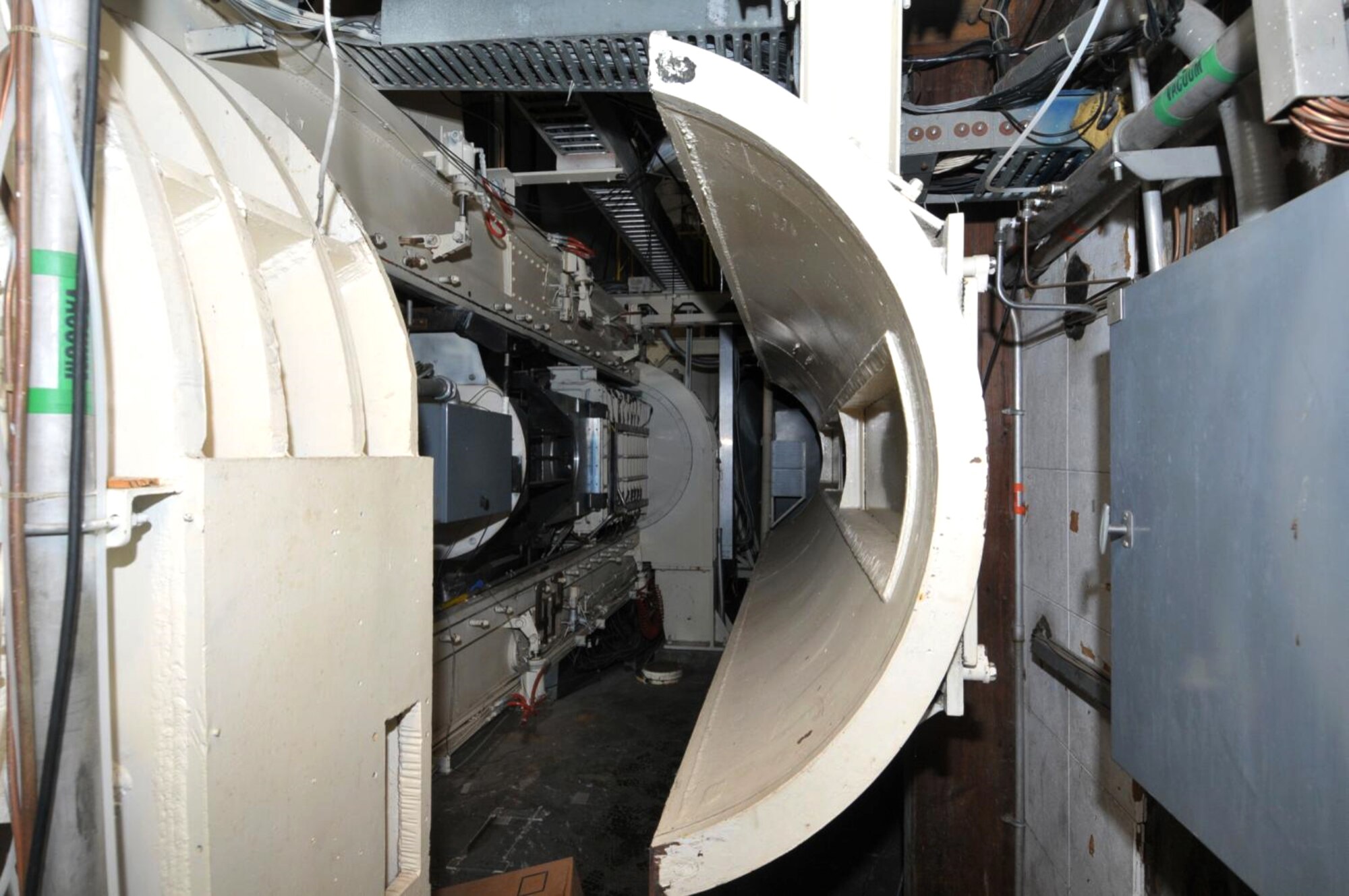 The plenum shell of the 1T wind tunnel at Arnold Air Force Base is retracted showing the test section of the tunnel.