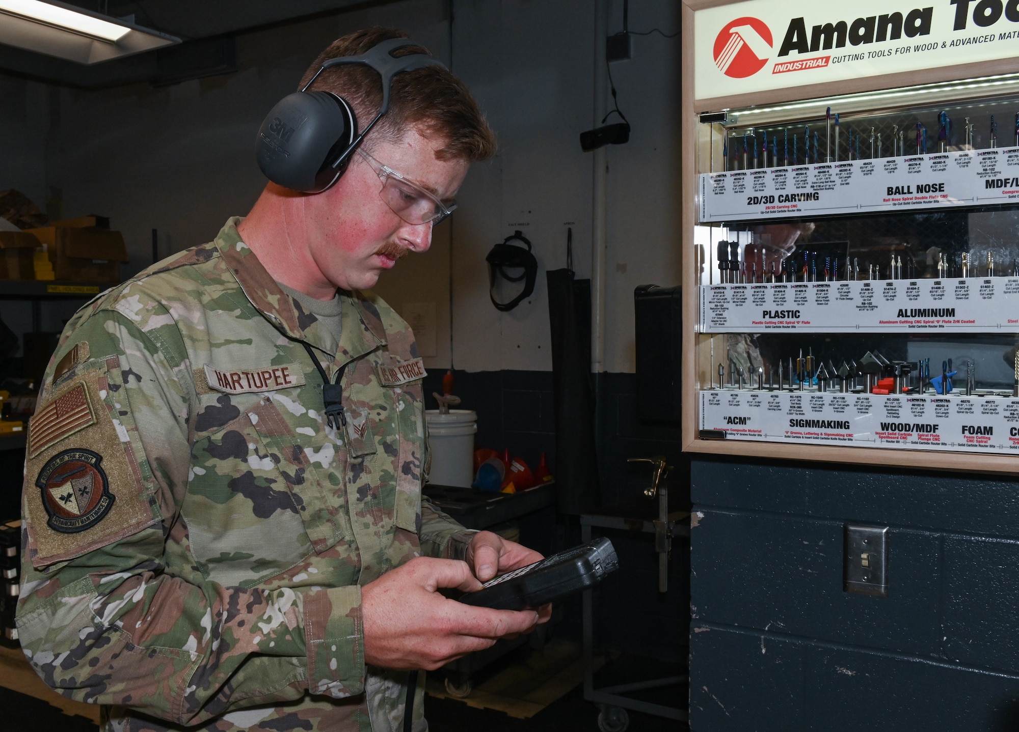 U.S. Air Force Senior Airman Robert Hartupee, 509th Sortie Support, composite tool kit technician operates Support's CNC machine at Whiteman Air Force Base, Missouri, October 12, 2022.Support is responsible for about $245 million worth of equipment. (U.S. Air Force photo by Airman 1st Class Hailey Farrell)