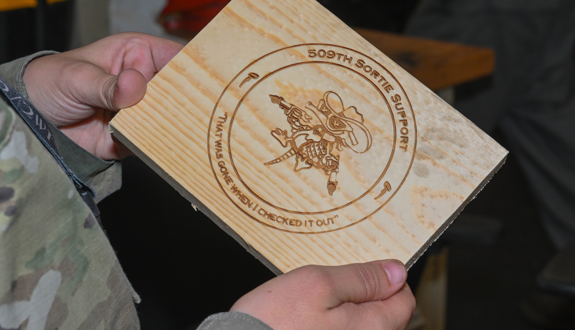 U.S. Air Force 509th Sortie Support CNC machine engraves the section's logo onto a piece of wood at Whiteman Air Force Base, Missouri, October 12, 2022. Support's mission is to provide serviceable equipment and tools needed for maintainers to perform their tasks. (U.S. Air Force photo by Airman 1st Class Hailey Farrell)
