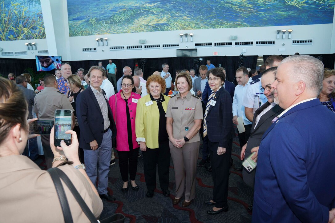 Army Gen. Laura Richardson, commander of U.S. Southern Command, poses for a photo with guests at a reception following the arrival of hospital ship USNS Comfort.