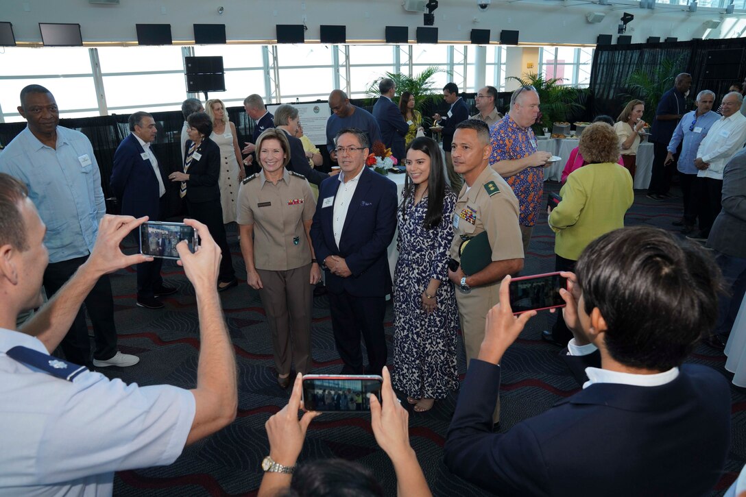Army Gen. Laura Richardson, commander of U.S. Southern Command, poses for a photo with guests at a reception following the arrival of hospital ship USNS Comfort.