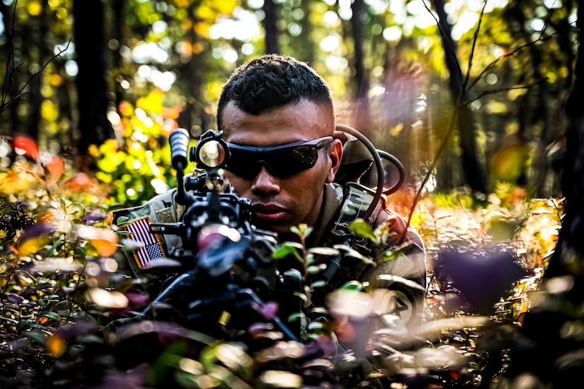 A U.S. Army Soldier assigned to the 113th Infantry Regiment conducts a platoon attack drill at Joint Base McGuire-Dix-Lakehurst, N.J. on Oct. 15, 2022. During the drill the platoon lead squad locates and suppresses the enemy, establishes supporting fire, and assaults the enemy position using fire and maneuver. The platoon destroys or causes the enemy to withdraw and conducts consolidation and reorganization thereafter. Once the platoon conducts action on enemy contact, the squad or section in contact reacts to contact by immediately returning well-aimed fire on known enemy positions. Dismounted Soldiers assume the nearest covered positions available and the element in contact attempts to achieve suppressive fires. Once achieved, the element leader notifies the platoon leader of the action.