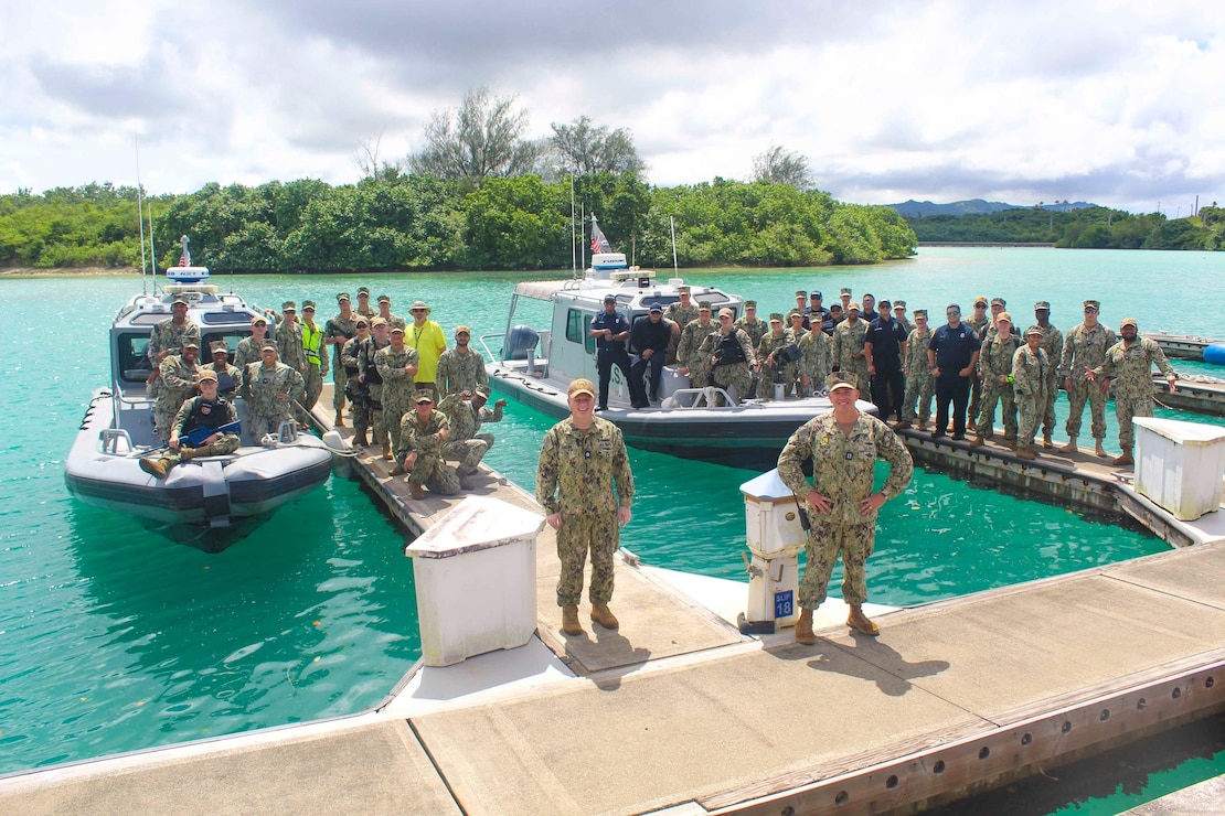 NAVAL BASE GUAM (Oct. 18, 2022) - U.S. Naval Base Guam (NBG) Acting Commanding Officer Cmdr. Stephen Ansuini and NBG Security Officer Lt. Eliot Fiaschi, along with Personnel from NBG Navy Security Forces (NSF) pose for a photo following the completion of a drill on Training Tuesday, Oct. 18.