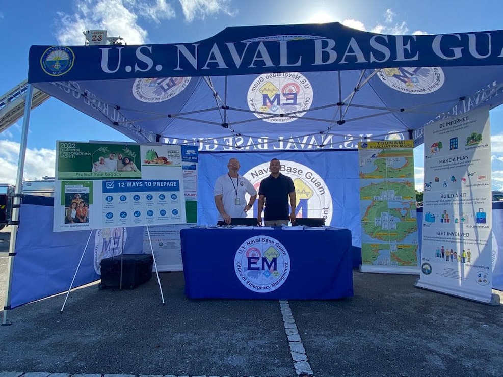 NAVAL BASE GUAM (Oct. 3, 2022) - Robert "Top" Ellsworth, U.S. Naval Base Guam (NBG) emergency management (EM) officer, and Clint Cruz, NBG emergency operations center manager, set-up an informational booth at the Dededo Farmer’s Market Sept. 30 as part of National Preparedness Month (NPM) finale event.