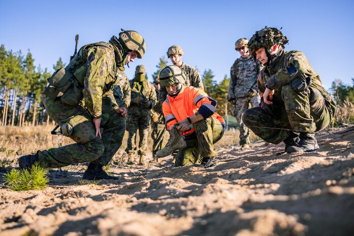 U.S. Marines with Combat Logistics Battalion 6, Combat Logistics Regiment 2, 2nd Marine Logistics Group, and Finnish Soldiers with Ekenas Coastal Battalion, prime a trinitrotoluene (TNT) explosive during an Explosive Ordnance Disposal range in preparation for exercise Freezing Winds 22 in Syndalen, Finland, Oct. 4, 2022.