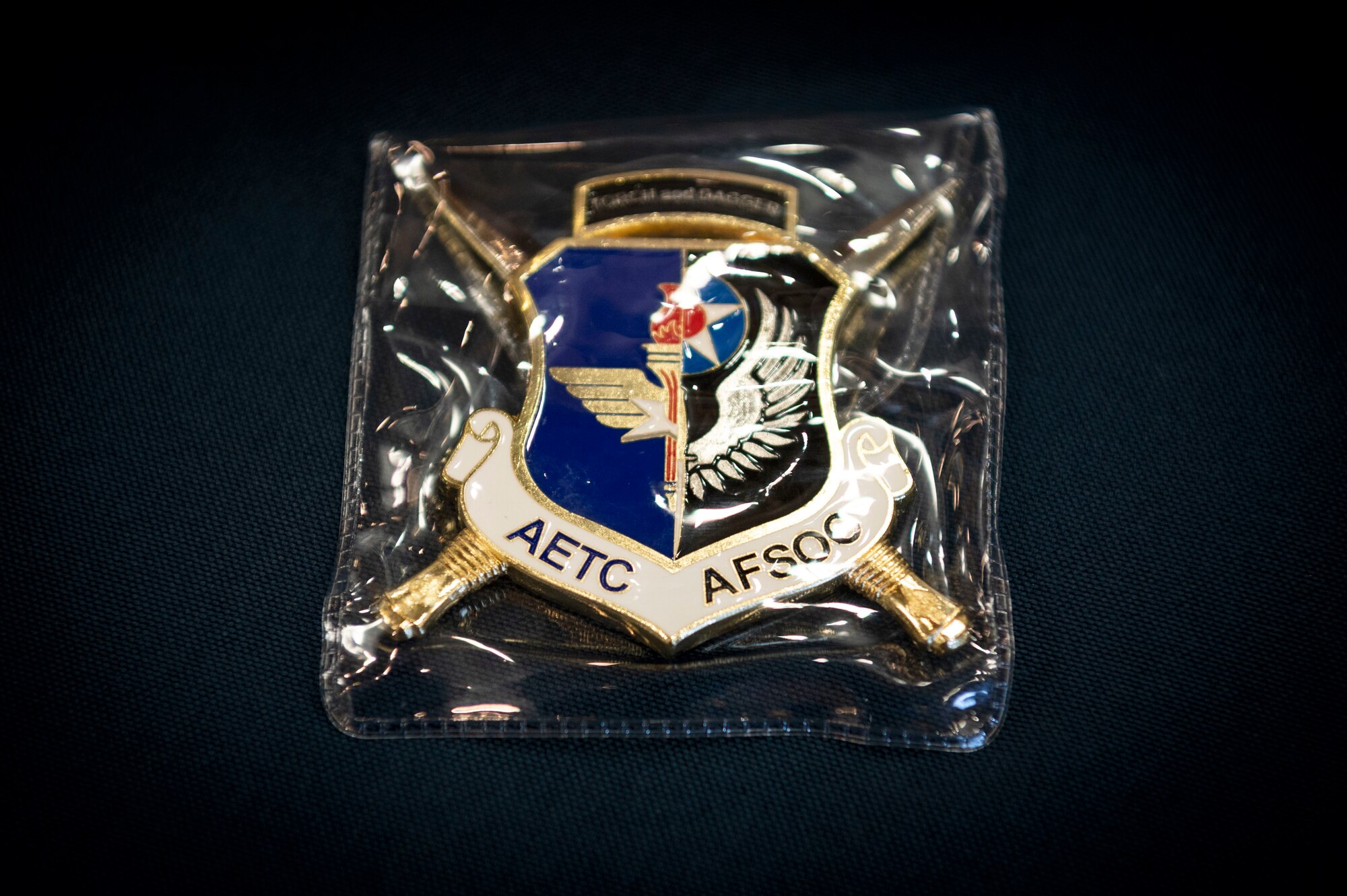 An Air Force Special Operations Command and Air Education and Training Command Order of the Sword coin is displayed at every table during an Order of the Sword ceremony at Keesler Air Force Base, Mississippi, Oct. 15, 2022.