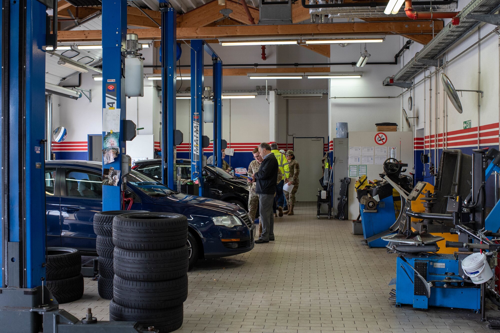 People inspect cars.