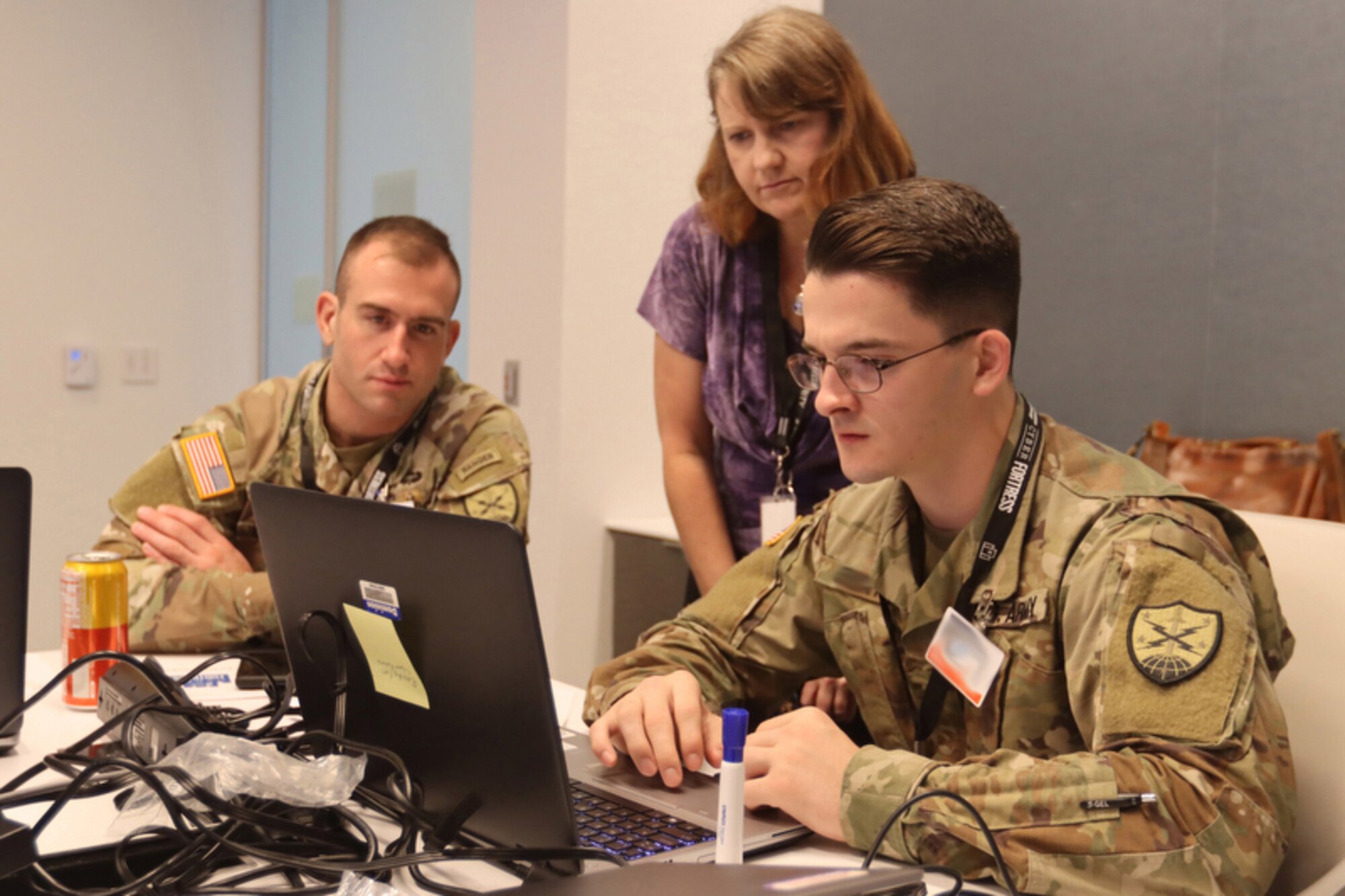 Virginia National Guard Soldiers assigned to the 91st Cyber Brigade work with civilian cyber specialists during the Cyber Fortress exercise Sept. 27, 2022, in Richmond, Virginia. (Photo digitally altered for security reasons.)