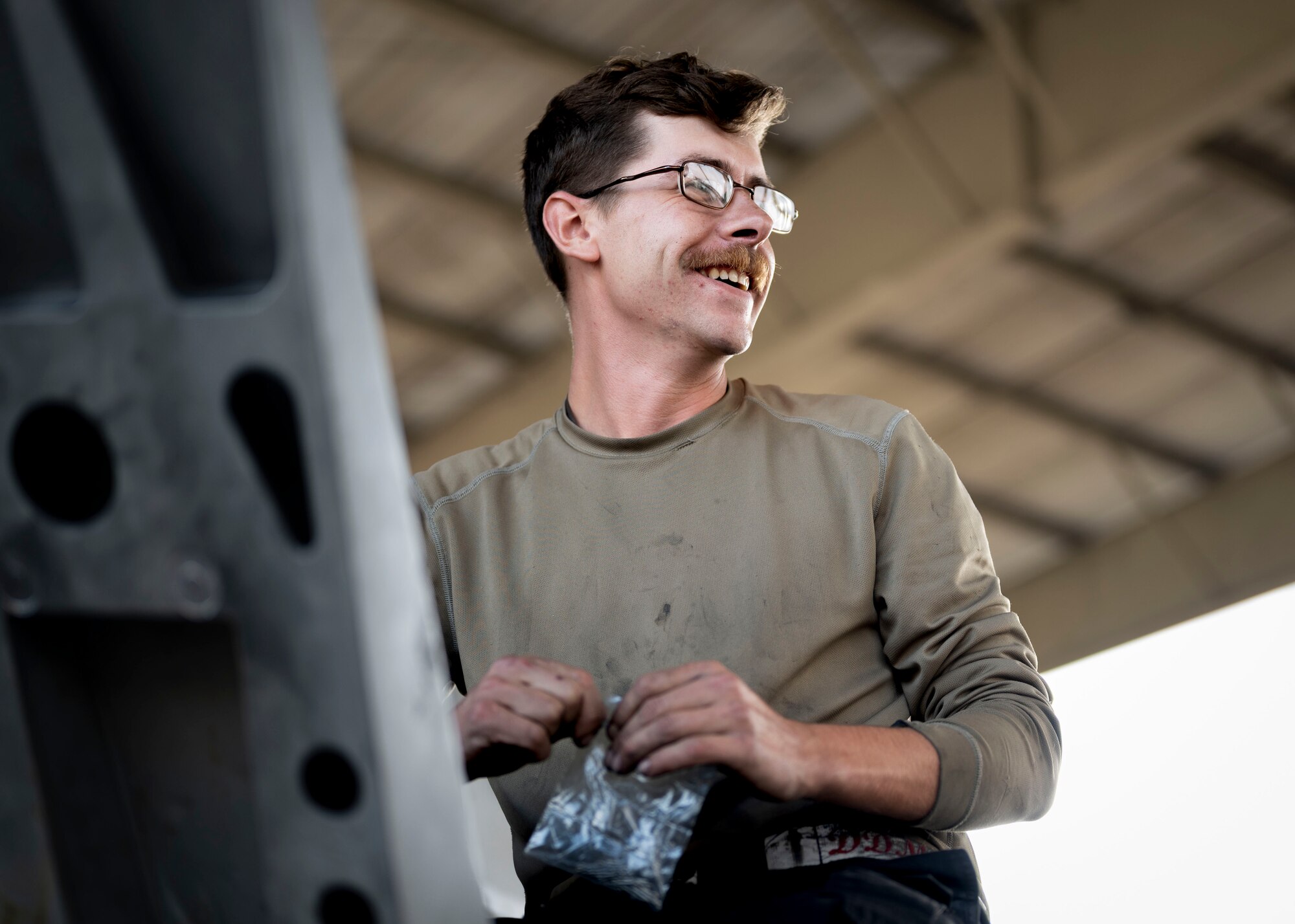 Airman works on top of a F-16C Fighting Falcon