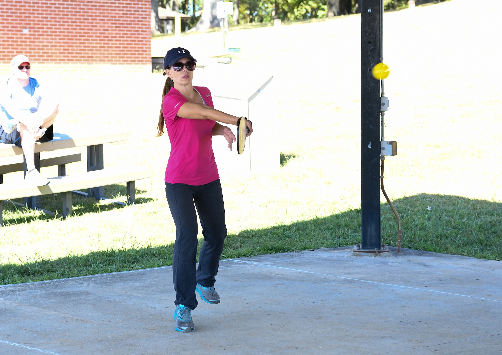 A woman plays pickleball