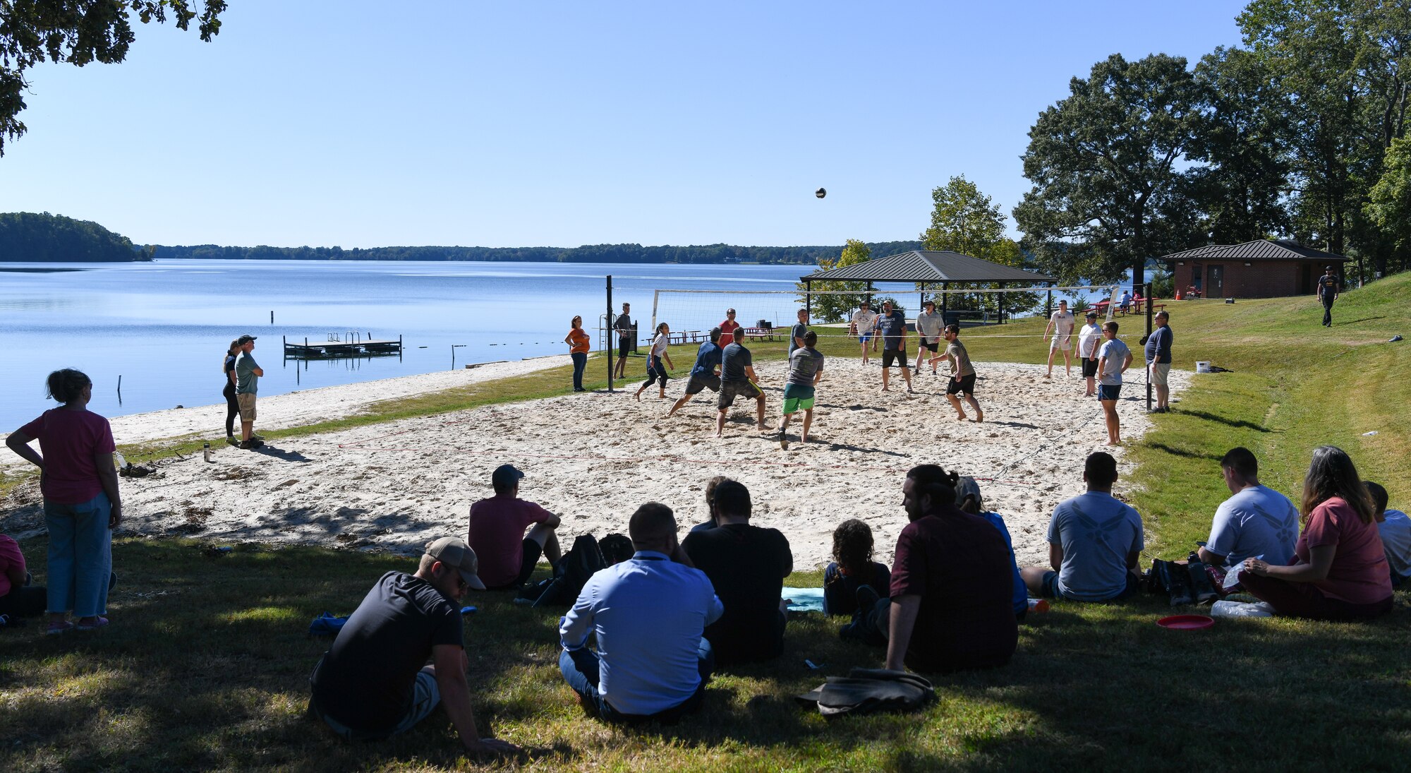 People watching a sand volleyball match