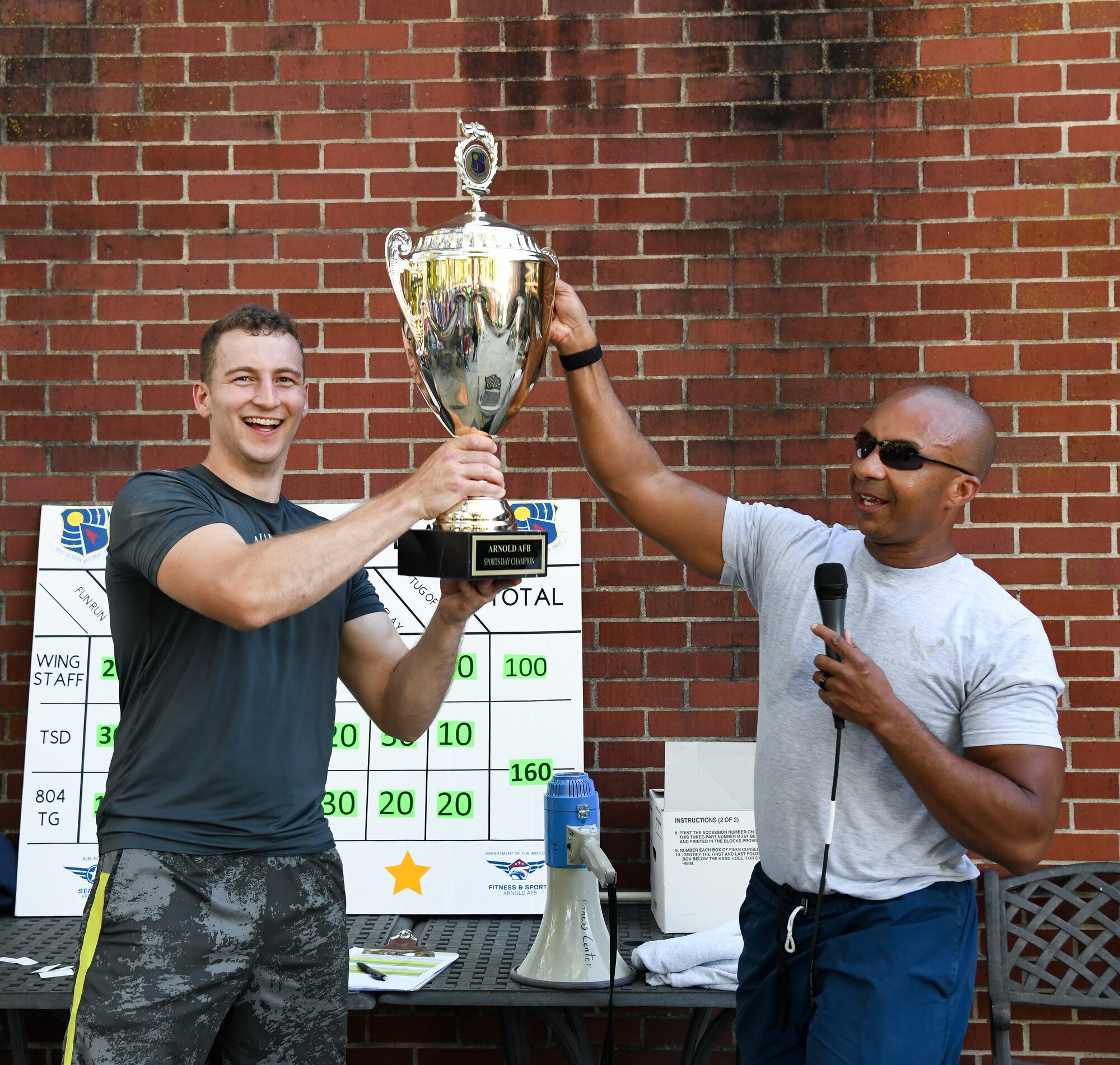 Airman presented trophy by Col. Randel Gordon