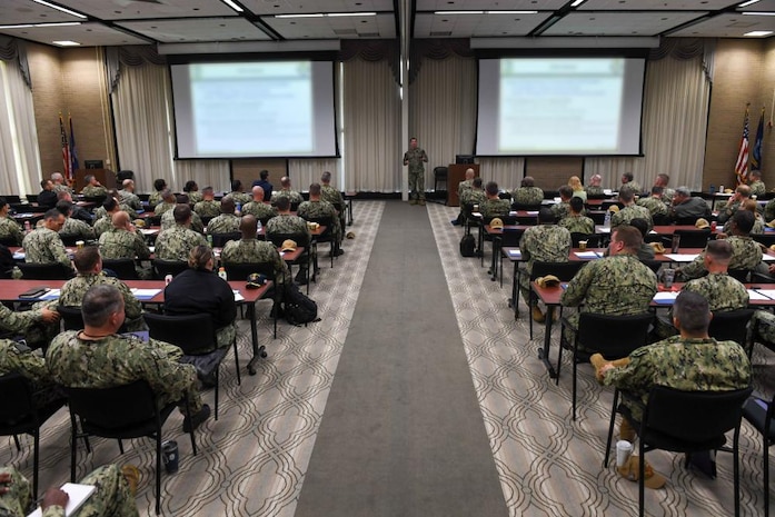 VIRGINIA BEACH, Va. (Oct. 17, 2022) Capt. Mac Harkin, deputy commodore, Destroyer Squadron 2, speaks during Naval Surface Force Atlantic (SURFLANT) Commander’s Training Symposium (CTS) 22-2, Oct. 18. CTS is a bi-annual, two-day leadership training event for flag officers, commanding officers, executive officers, and command senior enlisted leaders across the SURFLANT claimancy. (U.S. Navy photo by Mass Communication Specialist 1st Class Jacob Milham) (This photo has been edited for security purposes)