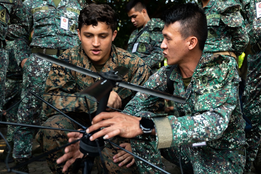 Marines  gather around a communications device.