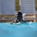 Sgt. Maurice Manns II with the 204th Maneuver  Enhancement Brigade, emerges for a breath during the swimming portion of the German Armed Forces Proficiency Badge , conducted at Camp Williams, Utah Oct. 16, 2022.