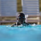 Sgt. Maurice Manns II with the 204th Maneuver  Enhancement Brigade, emerges for a breath during the swimming portion of the German Armed Forces Proficiency Badge , conducted at Camp Williams, Utah Oct. 16, 2022.
