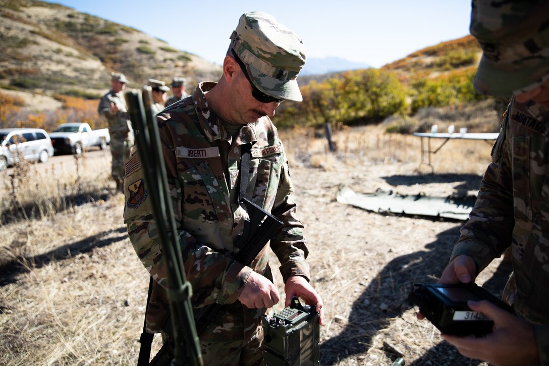 Utah Air National Guard Senior Master Sgt. Jeffery Uberti,  practices using a military communications radio during the Utah National Guard Best Warrior Competition, Oct. 17, 2022, at Camp Williams, Utah.