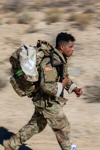 Spc. Cipriano Spier with the 204th Maneuver Enhancement Brigade, pushes through a 12-kilometer ruck march as part of the Utah National Guard Best Warrior Competition, Oct. 18, 2022, at Camp Williams, Utah.