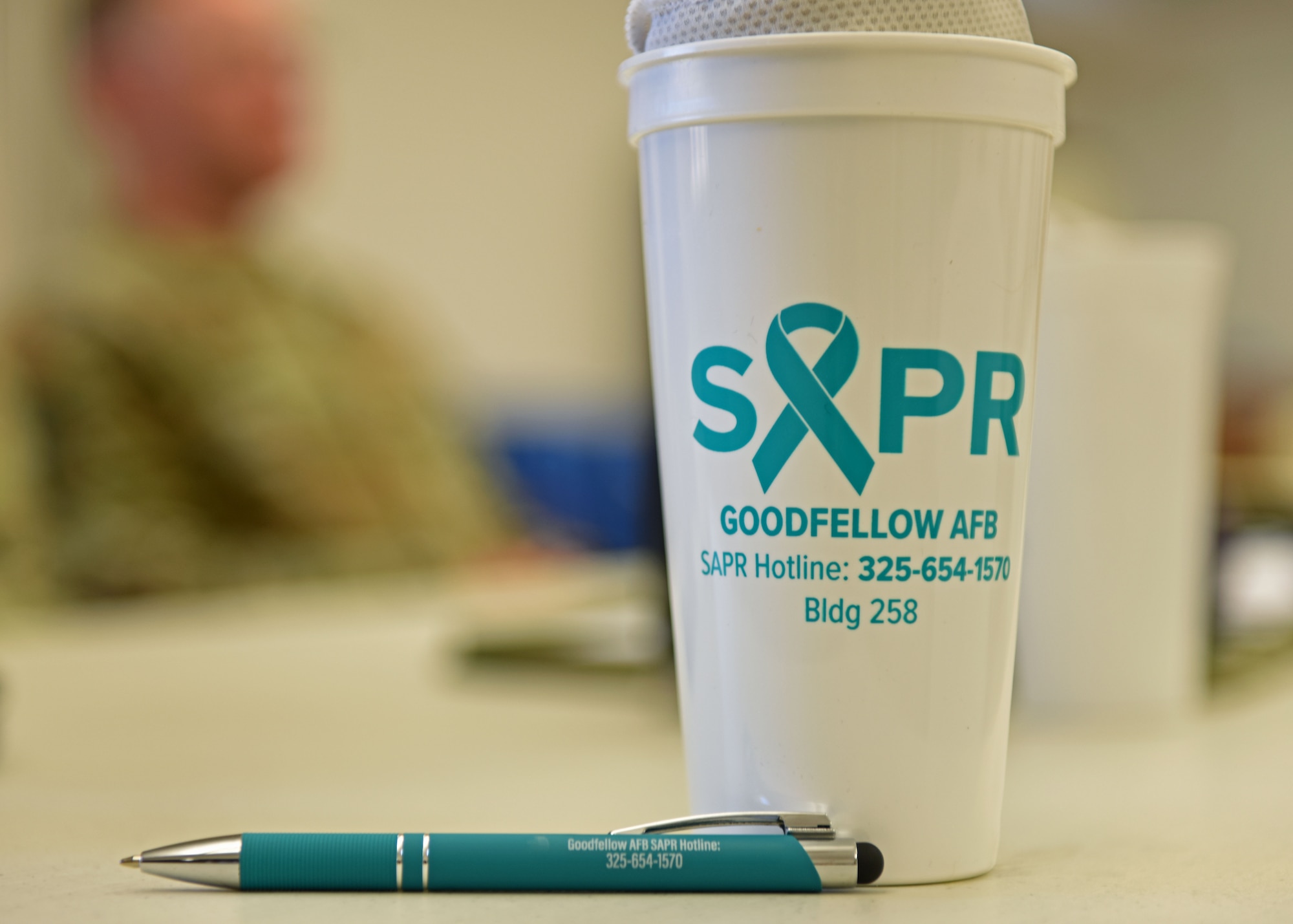 A Sexual Assault Prevention and Response cup sits on a table in the Taylor Chapel, Goodfellow Air Force Base, Texas, Oct. 21, 2022. The teal ribbon represents supporting survivors of sexual assault. (U.S. Air Force photo by Airman 1st Class Sarah Williams)