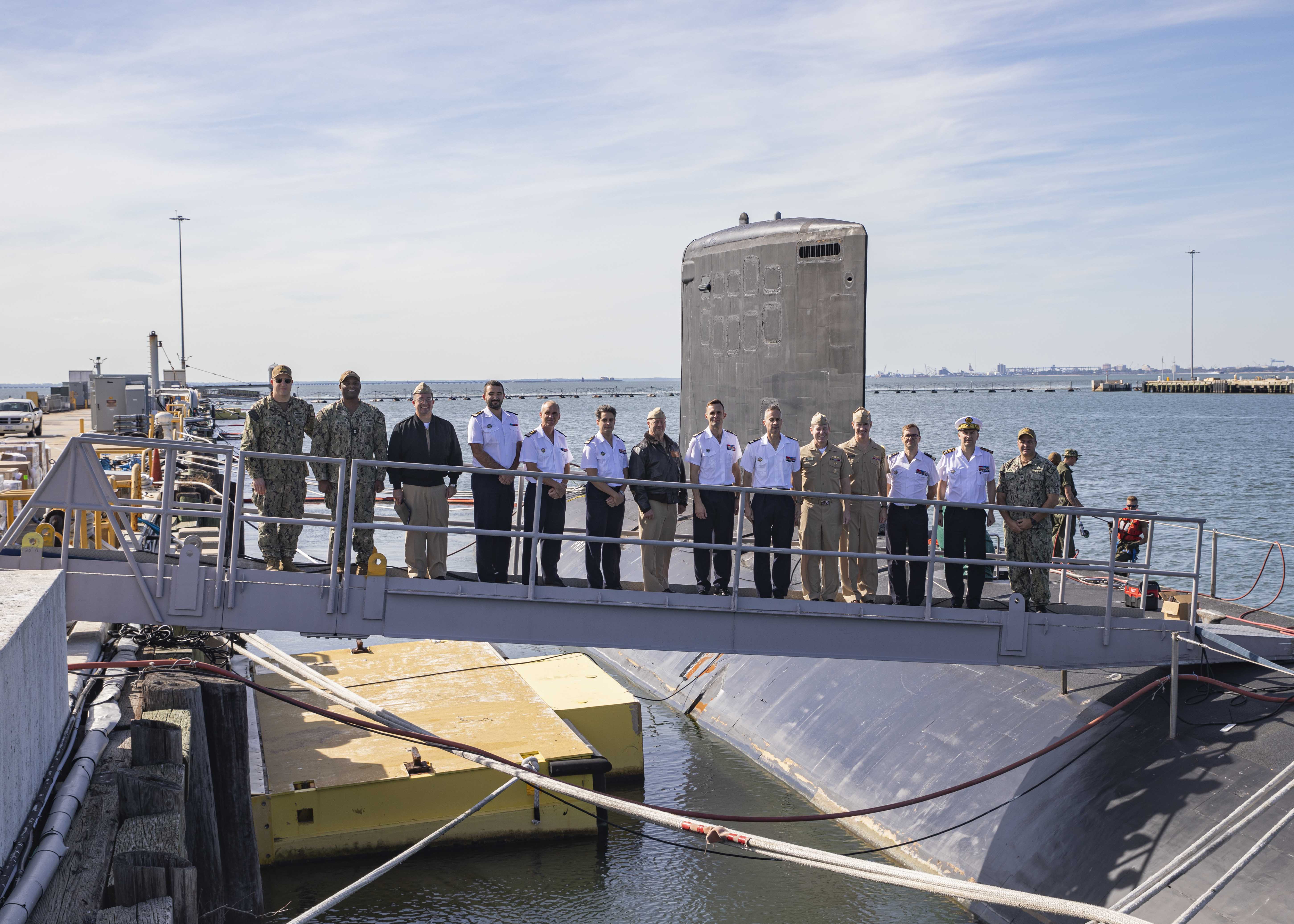 Leadership of the Virginia-class fast-attack submarine USS New Mexico (SSN 779) pose for a photo alongside U.S. and French submarine force leadership while touring the boat during a visit to Naval Station Norfolk, Oct. 11, 2022.