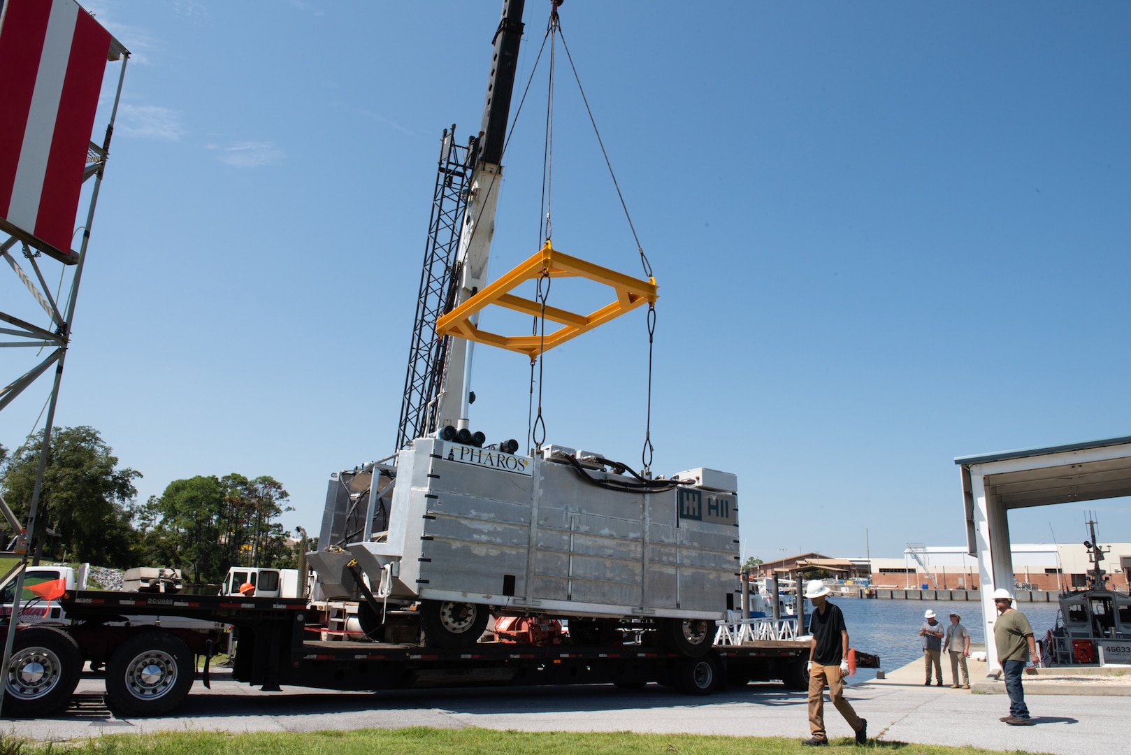 A crane prepares to lift the HII Pharos launch and recovery system from a trailer before launching it down the boat ramp at Naval Support Activity Panama City, Fla., Sept. 1. Naval Surface Warfare Center Panama City Division and HII entered into a Cooperative Research and Development Agreement to help demonstrate several of the system’s capabilities prior to its shipping to Naval Undersea Warfare Center (NUWC) Division Newport. (U.S. Navy photo by Ronnie Newsome)