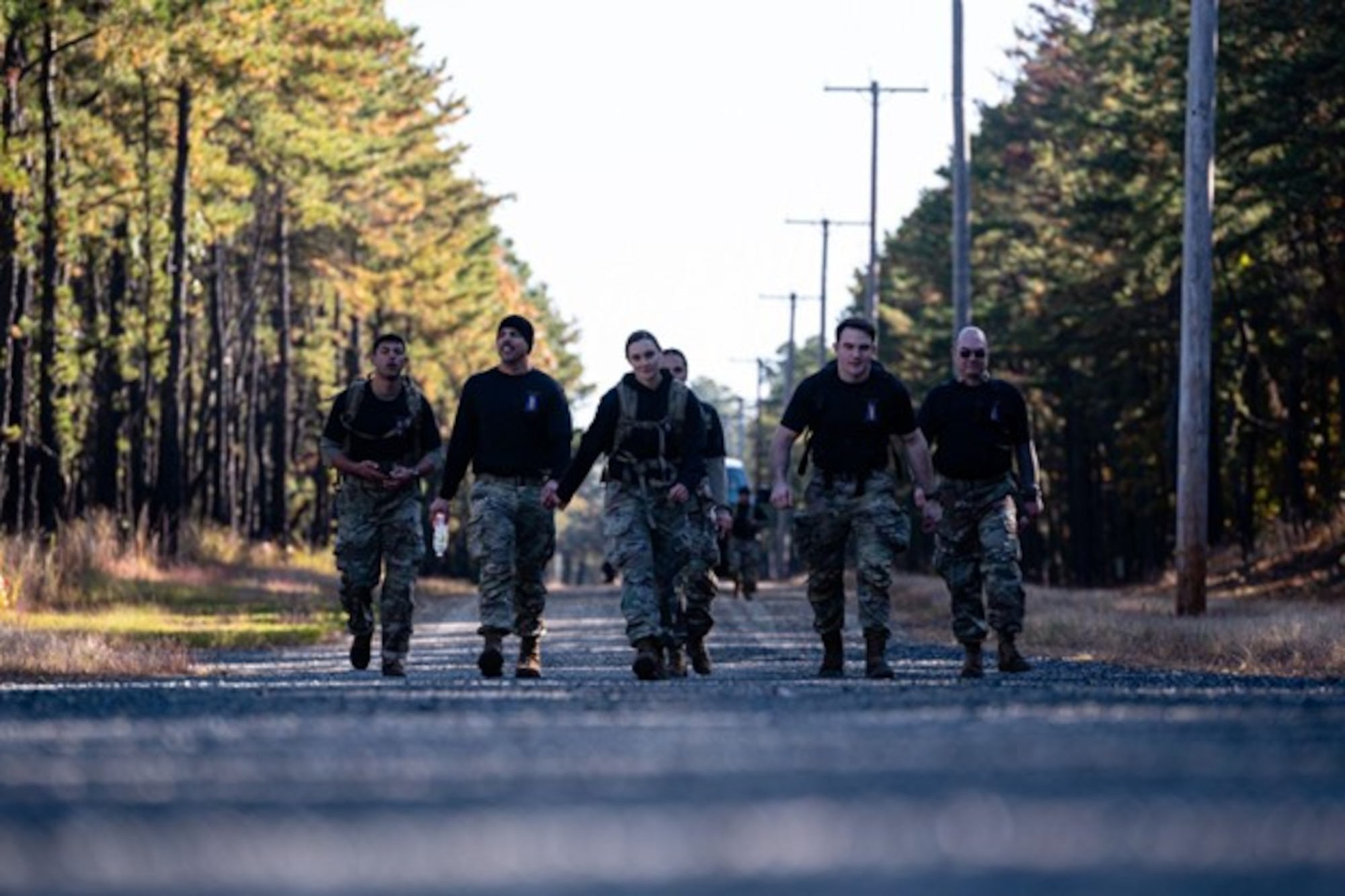 A group of people walk towards camera