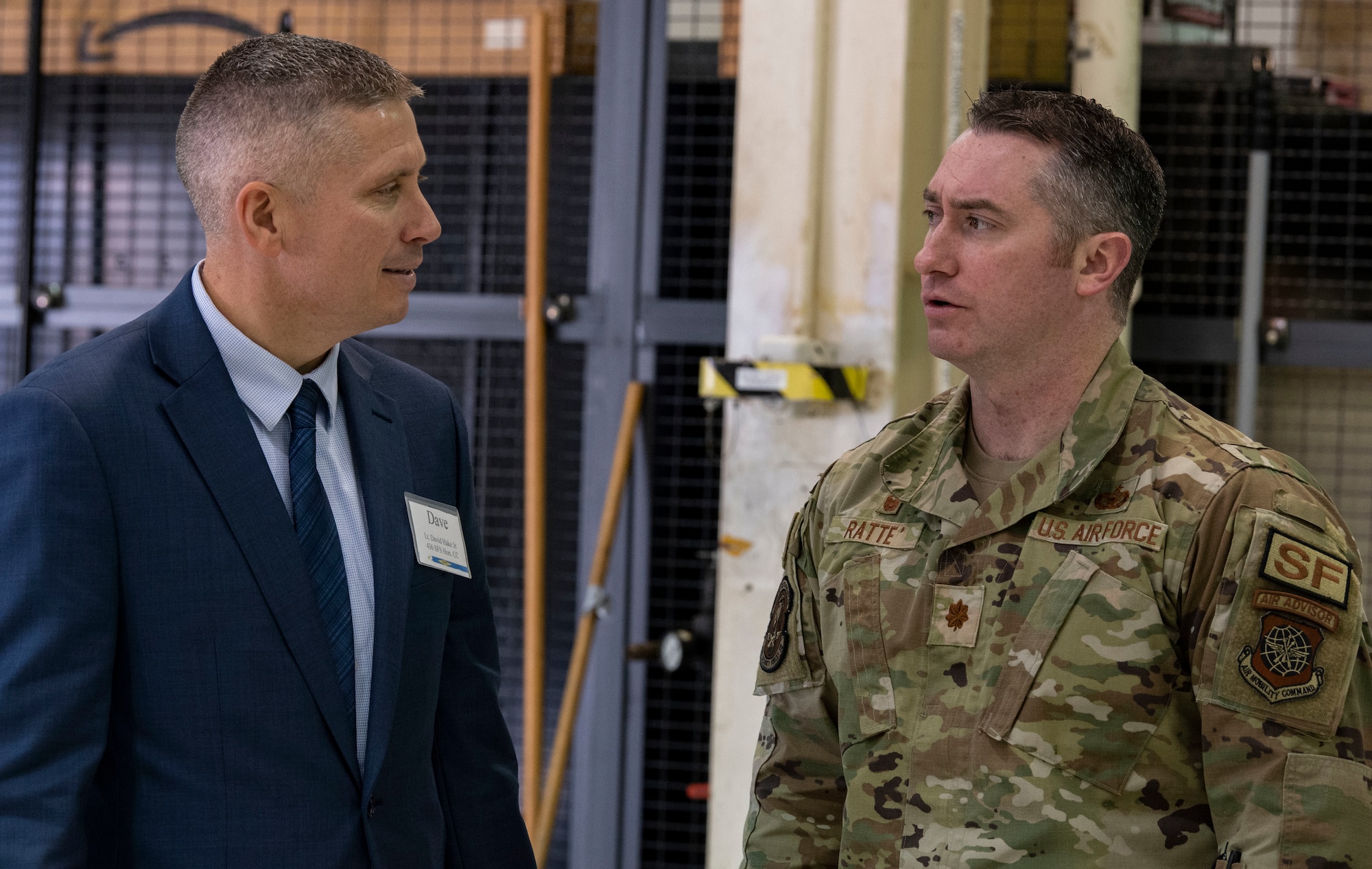 Lt. Dave Hake, left, Delaware State Police trooper, chats with Maj. David Ratte, 436th Security Forces Squadron commander, prior to the 2023 Honorary Commanders Induction Ceremony at Dover Air Force Base, Delaware, Oct. 20, 2022. Hake, along with forty-one other local civic and business leaders were inducted into the HCC program. He will serve as the HCC for the 436th SFS. (U.S. Air Force photo by Roland Balik)