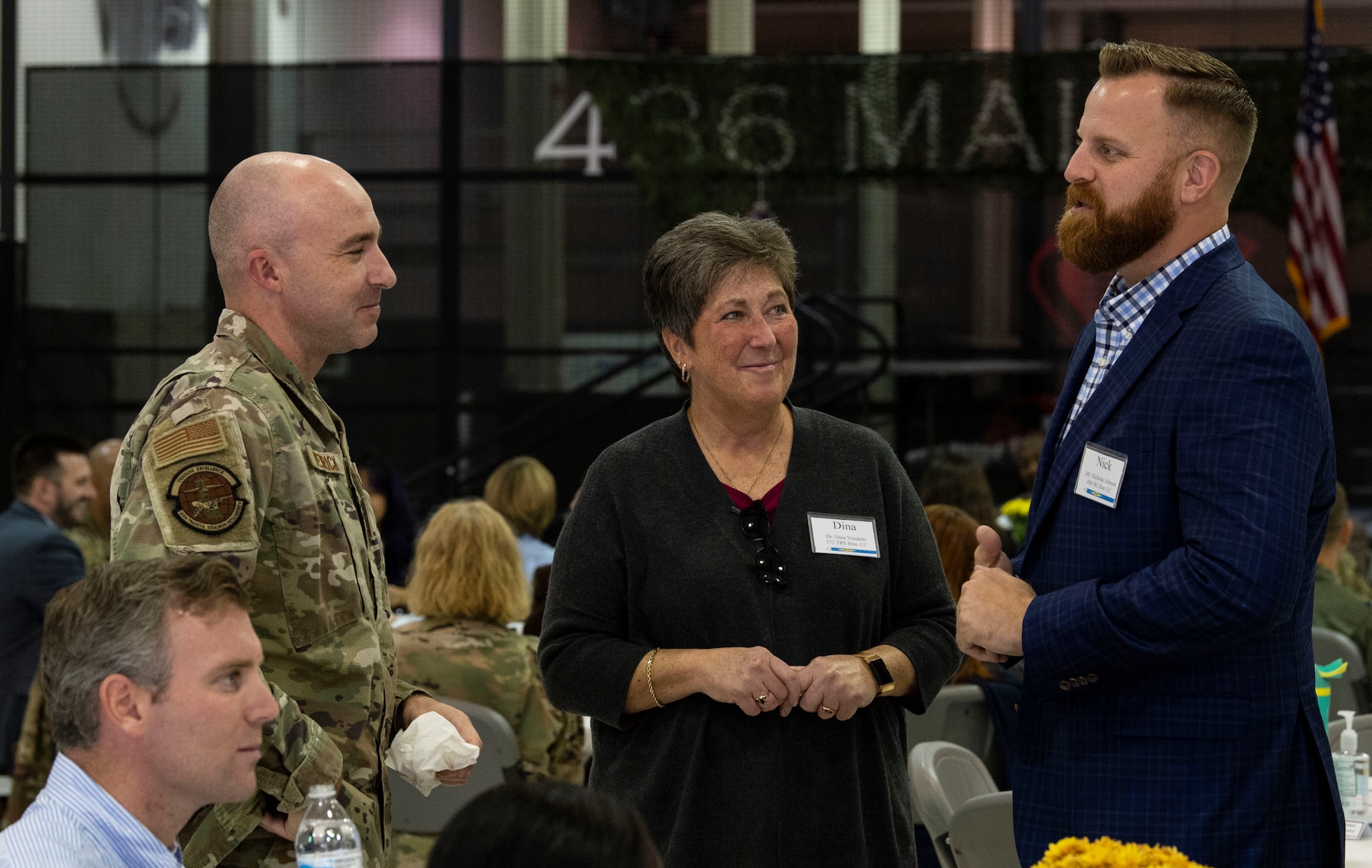 Nick Johnson, right, POLYTECH School District director of operations, chats with Dr. Dina Vendetti, Central Delaware Chamber of Commerce president, and Master Sgt. Andrew Wenrick, 373rd Training Squadron, Detachment 3 senior enlisted leader, prior to the 2023 Honorary Commanders Induction Ceremony at Dover Air Force Base, Delaware, Oct. 20, 2022. Johnson will serve as the HCC for the 436th Operations Group, and Vendetti will serve as the HCC for the 373rd TRS, Det 3. (U.S. Air Force photo by Roland Balik)