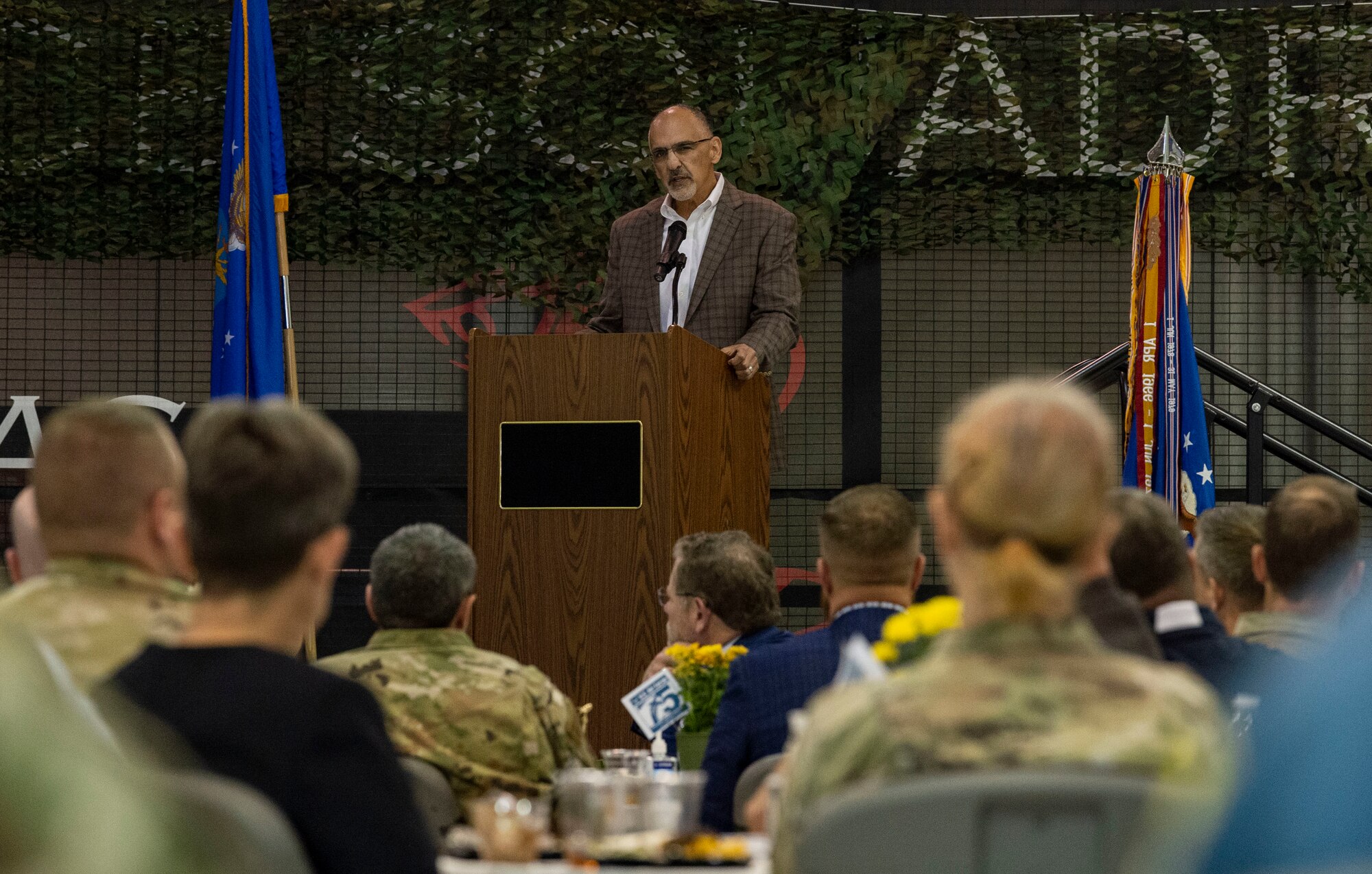 Mike Tatoian, Dover Motor Speedway current president and general manager, speaks to attendees at the 2023 Honorary Commanders Induction Ceremony at Dover Air Force Base, Delaware, Oct. 20, 2022. Tatoian has served several years in the United States Air & Space Forces Civic Leader Program and is the Chairman of the Advisory Council for USO Delaware, along with being a member of the USO Board of Directors-Northeast Region. He was the guest speaker for the event. (U.S. Air Force photo by Roland Balik)