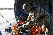 Sgt. Jordan Ford, crew chief with NHARNG aviation, straps in a 130-foot “long line” Oct. 19, 2022, at the Army Aviation Support Facility in Concord. Ford and his crew later extracted two rusted metal culverts from Nash Stream.