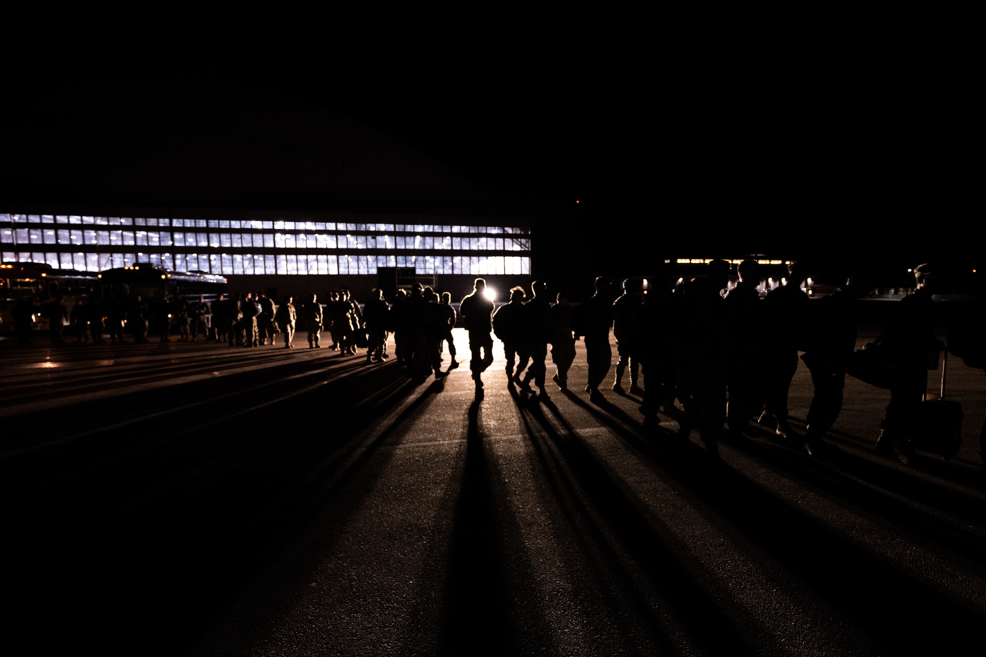 U.S. Airmen assigned to the 28th Bomb Wing begin boarding a Boeing 777 enroute to Andersen Air Force Base, Guam, at Ellsworth Air Force Base, South Dakota, on Oct. 14, 2022. Multicapable Airmen maintain a high state of readiness and proficiency, and validate our always-ready global strike capability. (U.S. Air Force photo by Senior Airman Austin McIntosh)