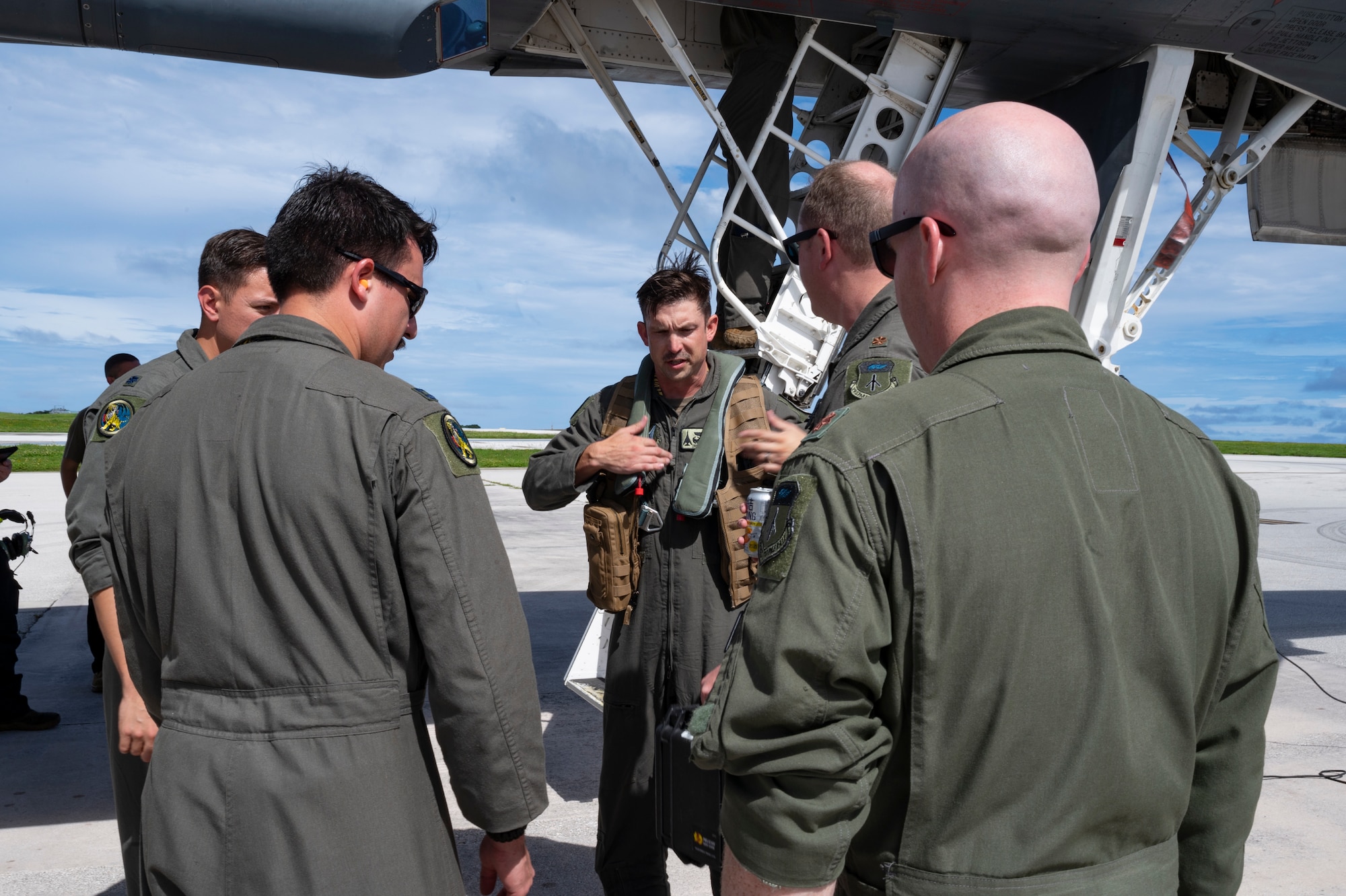 U.S. Air Force Col. Christopher McConnell, center, 37th Expeditionary Bomb Squadron commander, is greeted by aircrew upon arrival at Andersen Air Force Base, Guam, Oct. 18, 2022. Bomber Task Force missions support the National Defense Strategy objectives of strategic predictability and operational unpredictability through the speed, flexibility, and readiness of our strategic bombers. (U.S. Air Force photo by Staff Sgt. Hannah Malone)