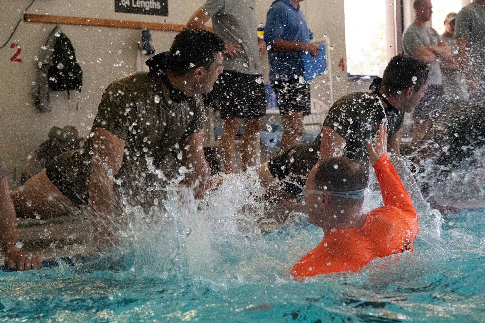 Pictured above is a man splashing water at people in the push-up position.