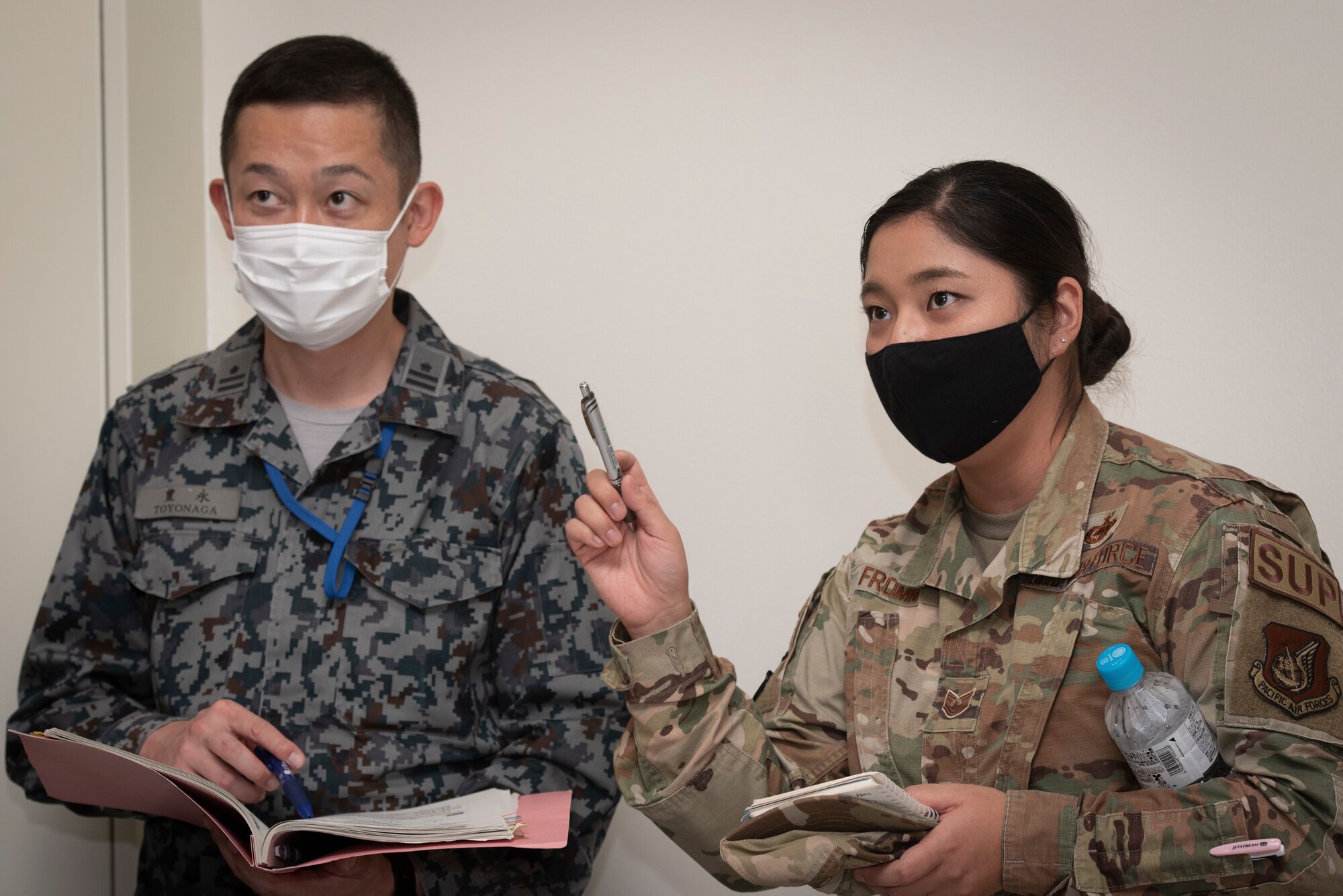 Tech. Sgt. Kanako Fromm, 374th Logistics Readiness Squadron decentralized materiel support section chief, translates for a member of the Japan Air Self-Defense Force during a bilateral civil engineer key leader engagement in the Emergency Operations Center at Yokota Air Force, Japan, Oct, 20, 2022