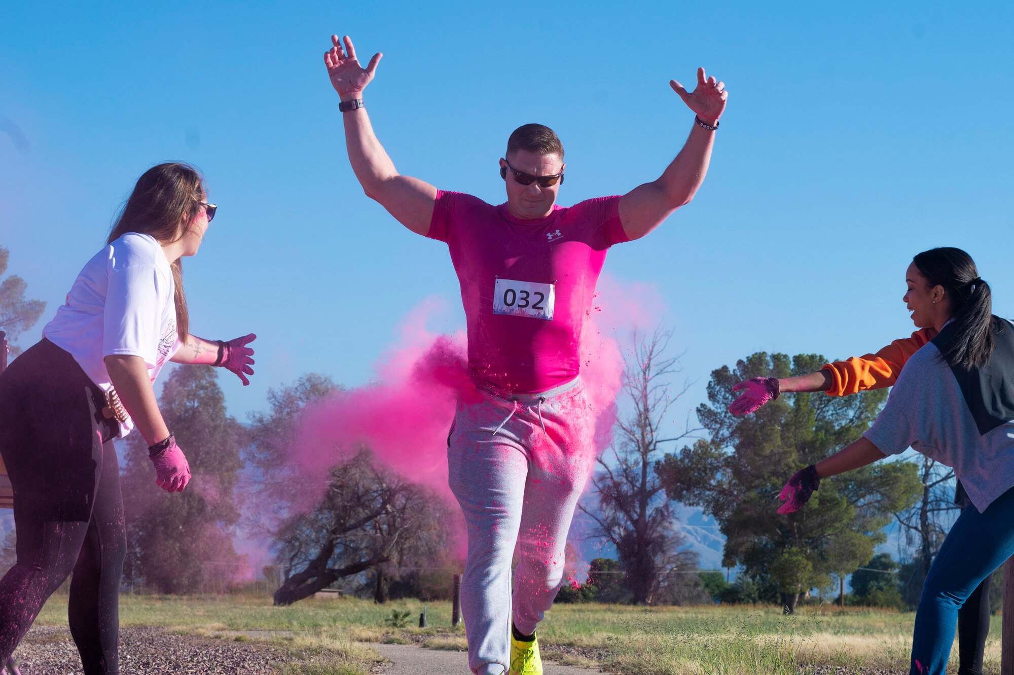 Pictured above is a man running through a cloud of pink smoke.