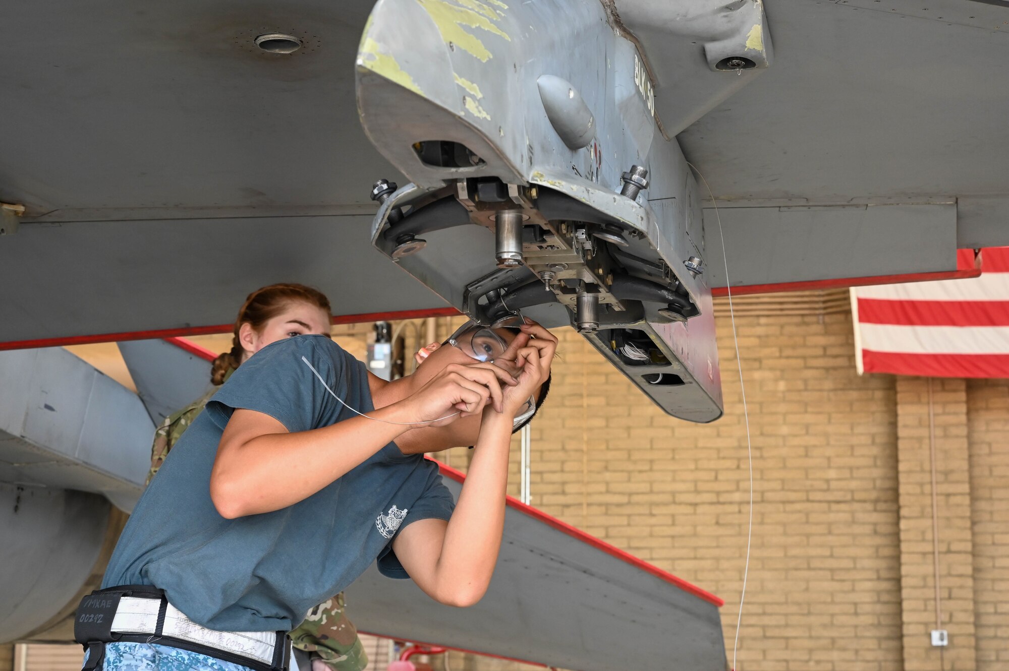 Singaporean air force ME1 Boon Soon Wong, 425th Aircraft Maintenance Unit maintainer, prepares an external hardpoint before loading a GBU-12 Paveway II bomb during a weapons load competition, Oct. 7, 2022, at Luke Air Force Base, Arizona.