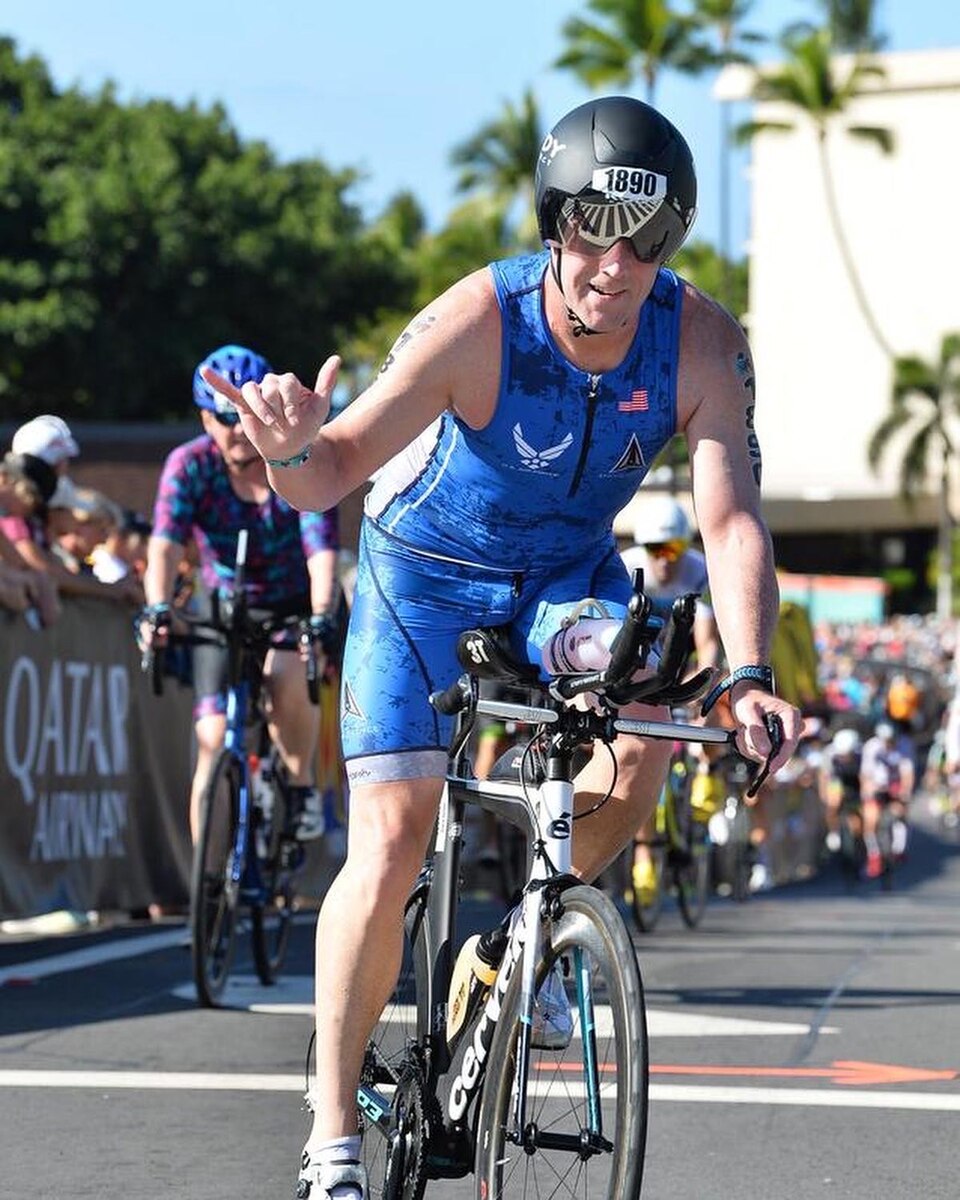 Photo of triathlon competitor cycling.