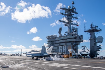 An F/A-18F Super Hornet, from the “Fighting Redcocks” of Strike Fighter Squadron (VFA) 22, makes an arrested gear landing on the aircraft carrier USS Nimitz (CVN 68).
