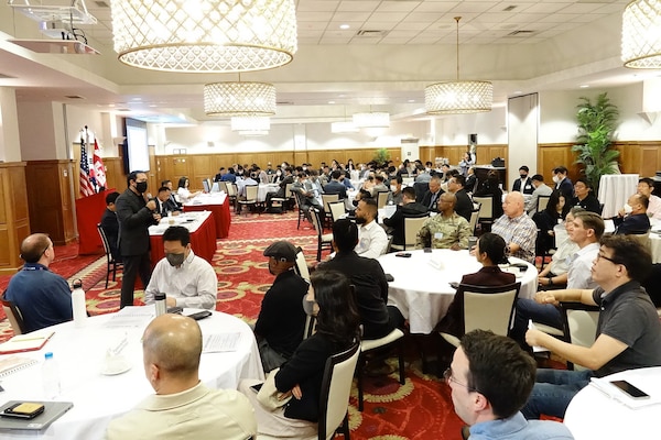 Sean Sackett (Left, standing), chief of the Contracting Division, briefs a presentation during Industry Day, which was held at the Riverbend Golf Course Ballroom, U.S. Army Garrison Humphreys, Oct. 6. The U.S. Army Corps of Engineers Far East District hosted Industry Day to help familiarize attendees with the projected business opportunities and to foster partnerships with industry and understand about its capabilities. The District will take feedback from the event to shape a $400 million Design-Build and Design-Bid-Build Multiple Award Task Order Contract (MATOC), which will be open Korea-wide. (U.S. Army photo by Yo Kyong-il)