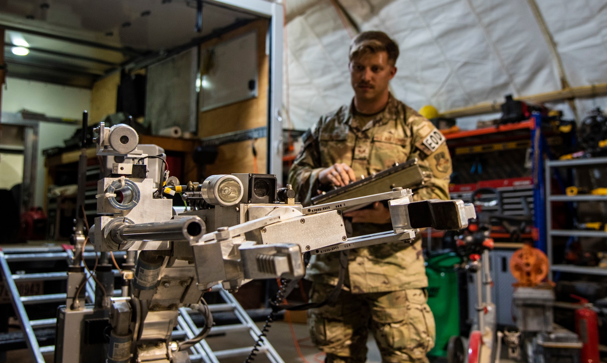 Senior Airman Kyle Riley, 332d Expeditionary Civil Engineering Squadron Explosive Ordnance Disposal Logistics Technician, operates an Andros F6A remotely-controlled robot at an undisclosed location in Southwest Asia, Oct. 14, 2022. Riley was instrumental in arranging repairs for this and other EOD tools, enhancing his unit's ability to respond to explosive threats. (U.S. Air Force photo by: Tech. Sgt. Jim Bentley)