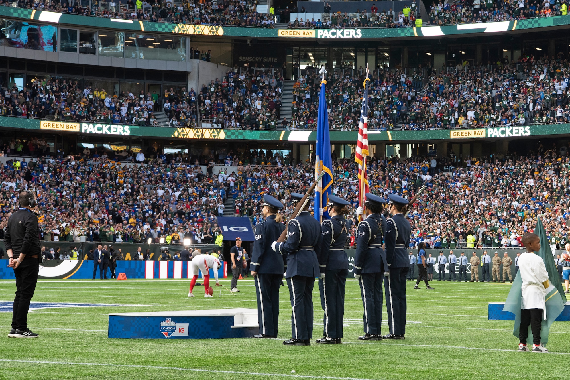U.S. Air Force Staff Sgt. Michelle Doolittle, U.S. Air Forces in Europe Band vocalist, stands in front of the 48th Fighter Wing Honor Guard before singing the U.S. National Anthem during the pre-game ceremony of the National Football League’s New York Giants vs. Green Bay Packers game at Tottenham Hotspur Stadium, in London, England, Oct. 9, 2022. As part of the pre-game ceremony, Airmen presented a U.S. Flag alongside a U.K. flag presented by British service members. The Giants defeated the Packers 27-22. (U.S. Air Force photo by Tech. Sgt. Anthony Hetlage)