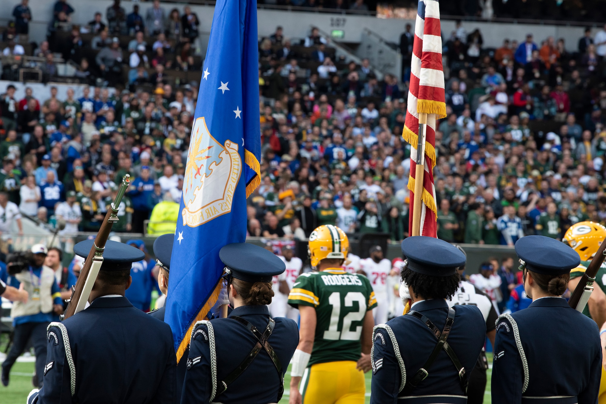U.S. Airmen from the 48th Fighter Wing Honor Guard stand on the field as Aaron Rodgers, Green Bay Packers quarterback, walks by before the pre-game ceremony of the National Football League’s New York Giants vs. Green Bay Packers game at Tottenham Hotspur Stadium, in London, England, Oct. 9, 2022. This was the second NFL game in England this year which featured Airmen from Royal Air Force Mildenhall and RAF Lakenheath unfurling a U.S. Flag during the pre-game ceremony. (U.S. Air Force photo by Tech. Sgt. Anthony Hetlage)