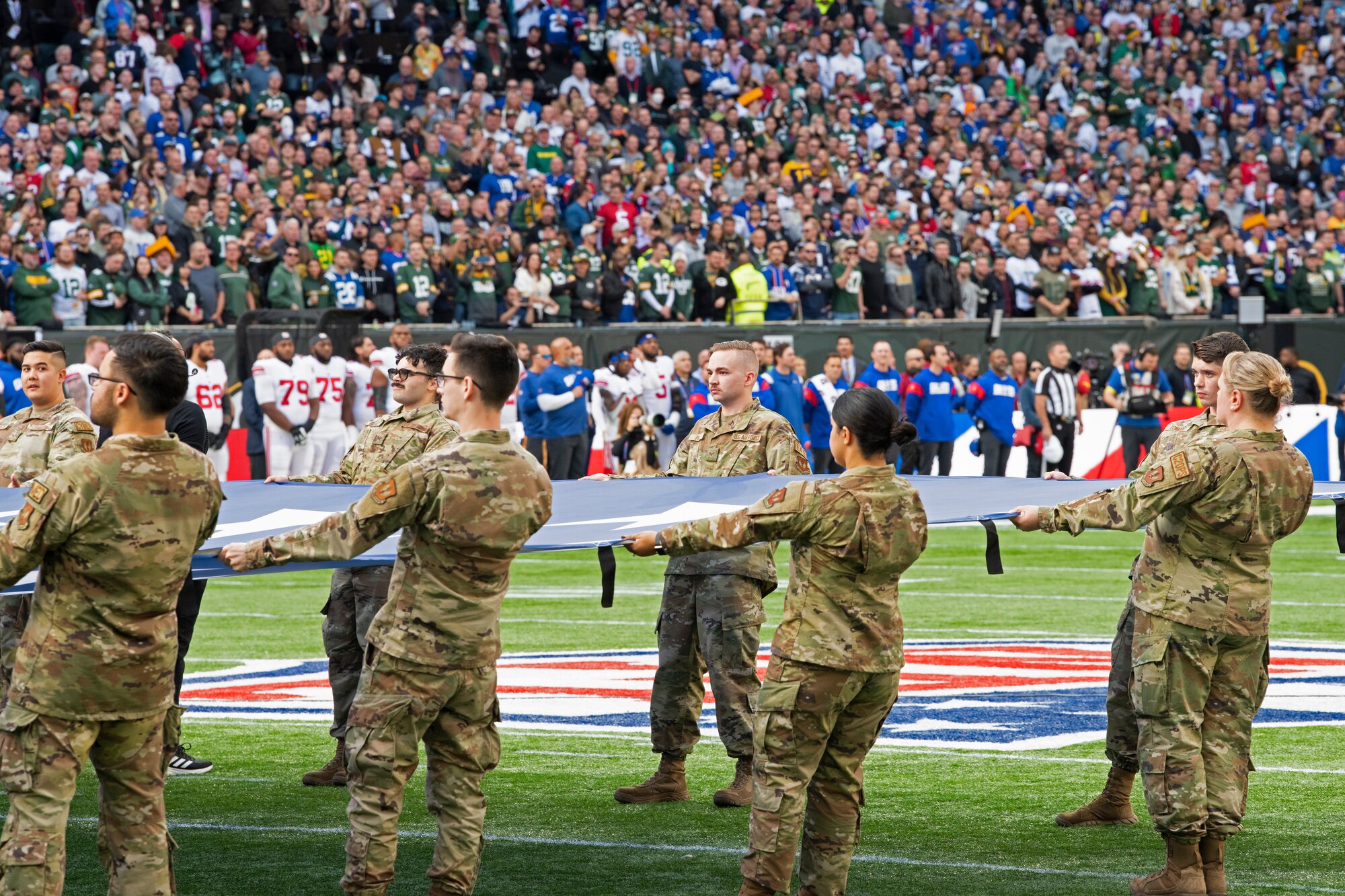 U.S. Airmen assigned to Royal Air Force Mildenhall and RAF Lakenheath hold an unfurled U.S. Flag during the pre-game ceremony of the National Football League’s New York Giants vs. Green Bay Packers game at Tottenham Hotspur Stadium, in London, England, Oct. 9, 2022. As part of the pre-game ceremony, Airmen presented a U.S. Flag alongside a U.K. flag presented by British service members. The Giants defeated the Packers 27-22. (U.S. Air Force photo by Tech. Sgt. Anthony Hetlage)