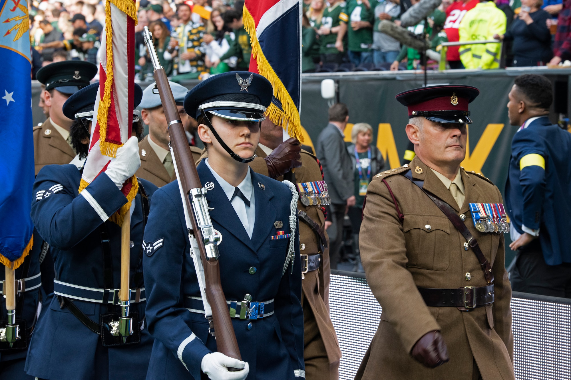 U.S. Air Force Airman 1st Class Olivia Gibson, 48th Fighter Wing honor guardsman, marches off the field with a U.K. Armed Forces color guard team after the pre-game ceremony of the National Football League’s New York Giants vs. Green Bay Packers game at Tottenham Hotspur Stadium, in London, England, Oct. 9, 2022. The pre-game ceremony featured more than 50 Airmen unfurling the flag along with an honor guard team and vocalist to sing the U.S. National Anthem. (U.S. Air Force photo by Tech. Sgt. Anthony Hetlage)