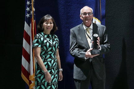 Shawn Egnak from Naval Surface Warfare Center, Philadelphia Division is presented with the Individual Innovator during the annual V.B. (Kisan) Pandit Innovation Awards for Metrology and Calibration (METCAL) at Naval Sea Systems Command Headquarters in Washington, D.C., May 18, 2022. Egnak was presented the award by NAVSEA Executive Director Giao Phan. (U.S. Navy Photo by Laura Lakeway, Released)