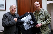 Stonewall Inn’s Kurt Kelly presents a t-shirt to Naval Surface Warfare Center, Philadelphia Division Commanding Officer Capt. Dana Simon during the Joint Warfare Center’s Pride Across America event on June 28, 2022. (U.S. Navy photo by Akenda Steward/Released)
