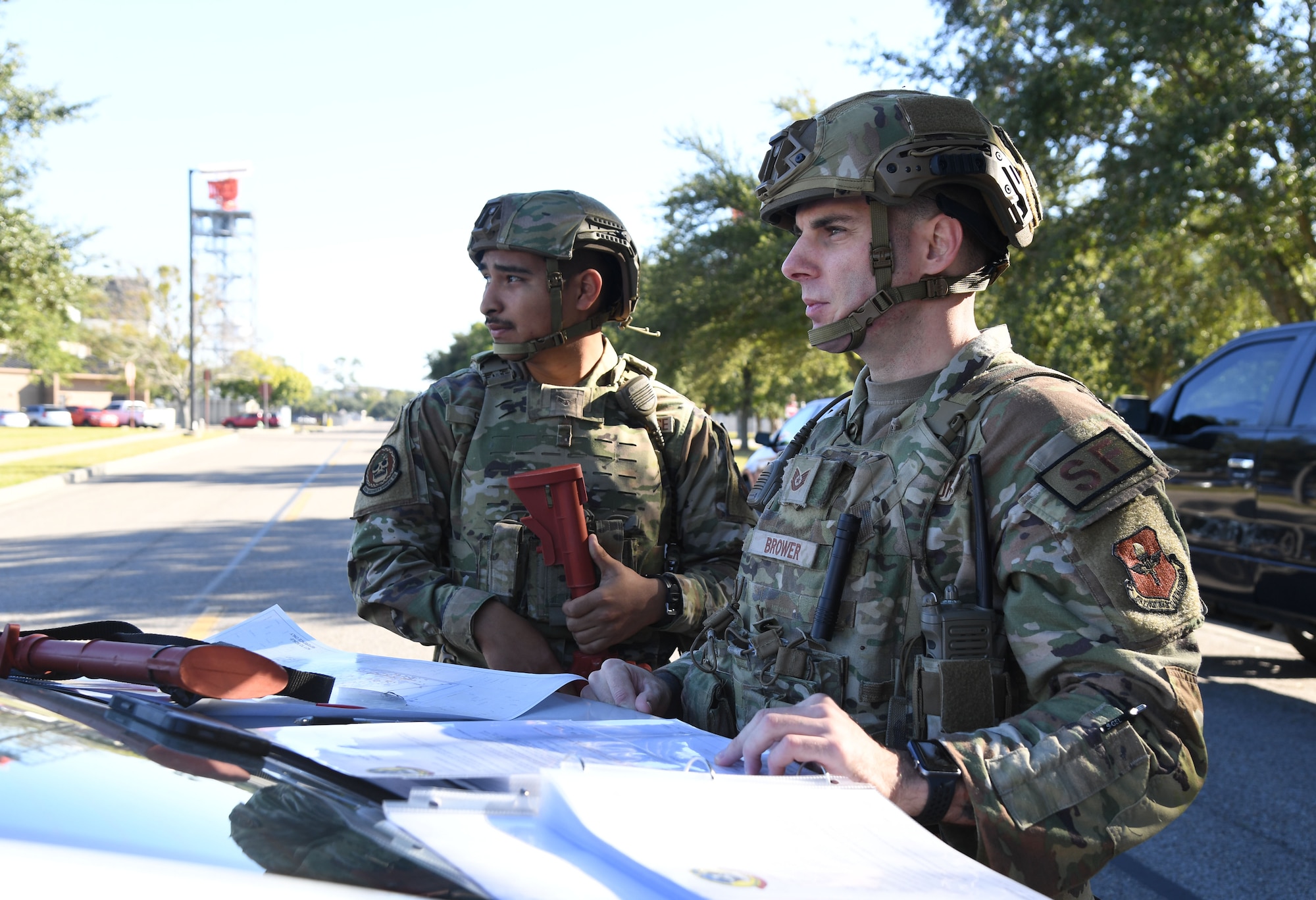 U.S. Air Force Airman 1st Class Angel Silva, 81st Security Forces Squadron entry controller, and Tech. Sgt. Brian Brower, 81st SFS flight sergeant, review checklists and plot cordons during an active shooter exercise outside the Levitow Training Support Facility at Keesler Air Force Base, Mississippi, Oct. 20, 2022.