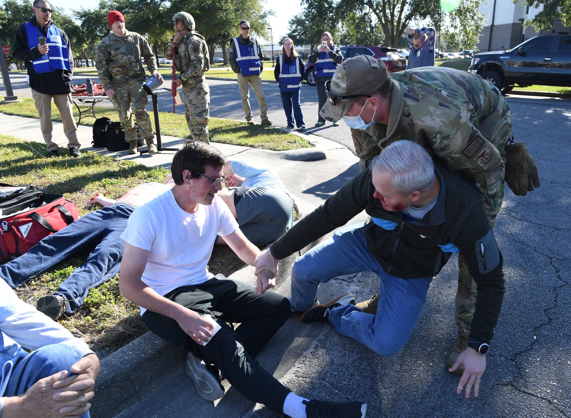 U.S. Air Force Staff Sgt. Trevor McCleary, 81st Civil Engineer Squadron lead firefighter, assists Airmen portraying victims to the triage area during an active shooter exercise outside the Levitow Training Support Facility at Keesler Air Force Base, Mississippi, Oct. 20, 2022.