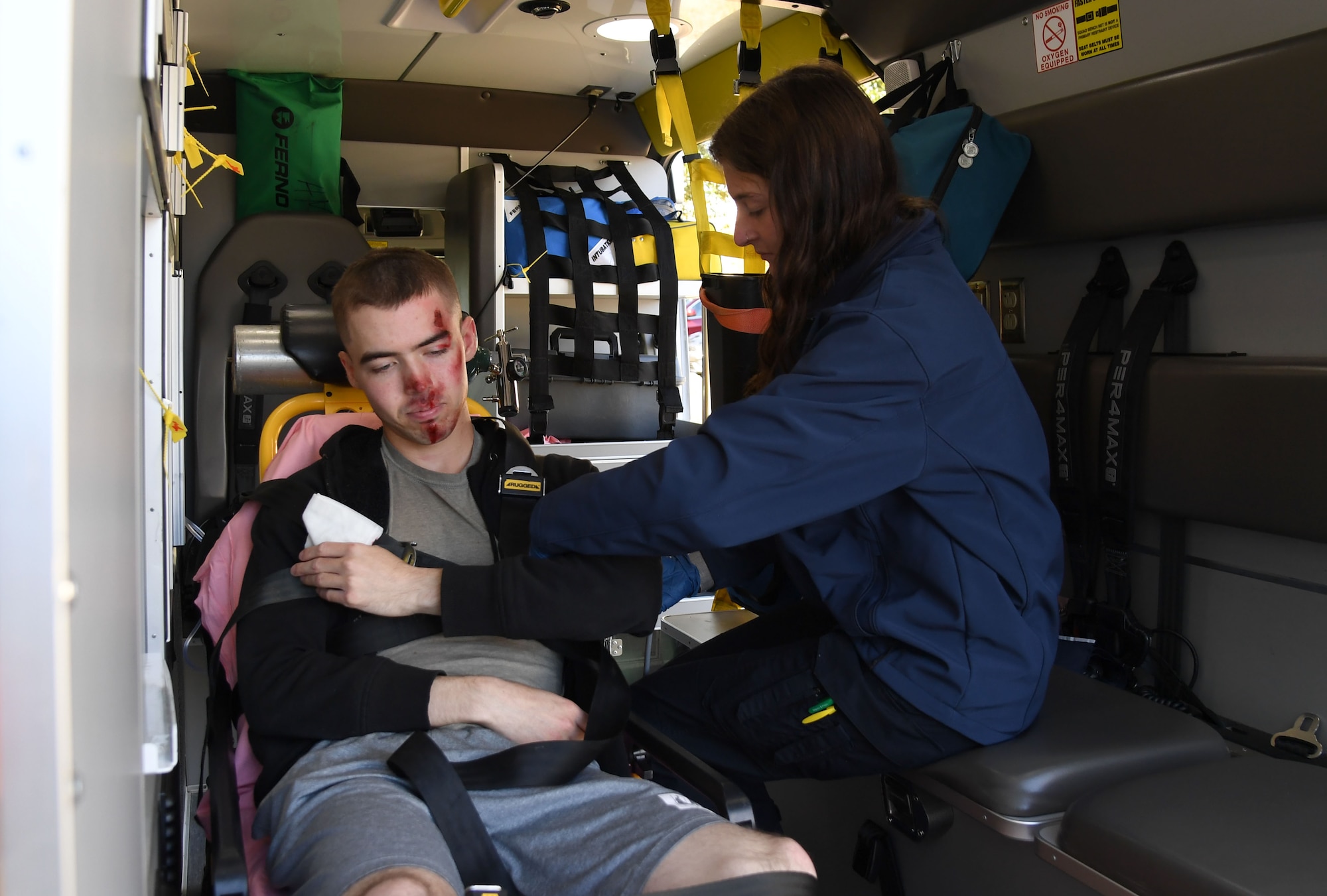 Daneal Barndt, American Medical Response emergency medical technician basic, checks vitals on U.S. Air Force Airman Tommy Williams, 338th Training Squadron student, who portrays a victim, during an active shooter exercise outside the Levitow Training Support Facility at Keesler Air Force Base, Mississippi, Oct. 20, 2022.